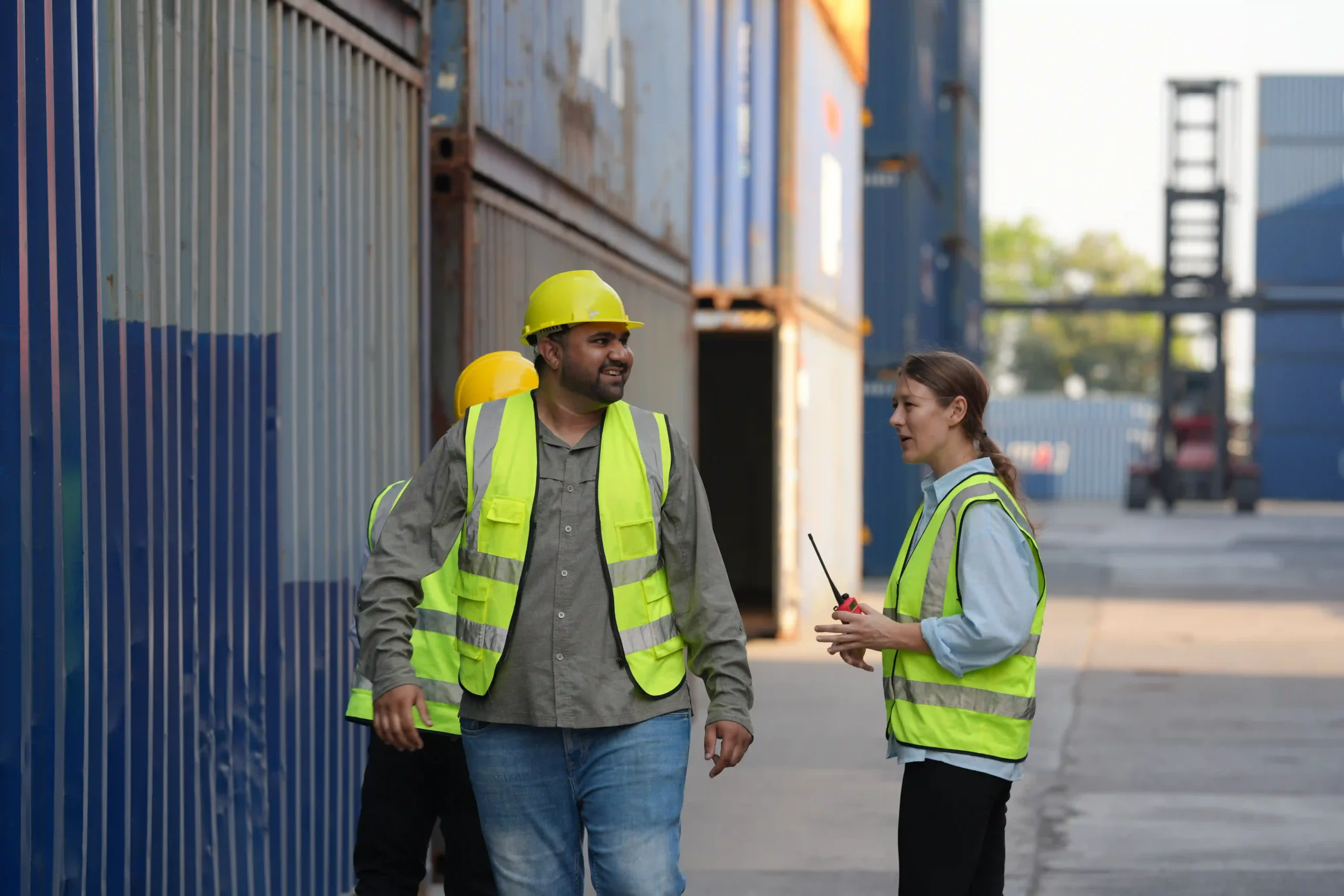 Logistics professionals coordinating last-mile delivery at a cargo facility.