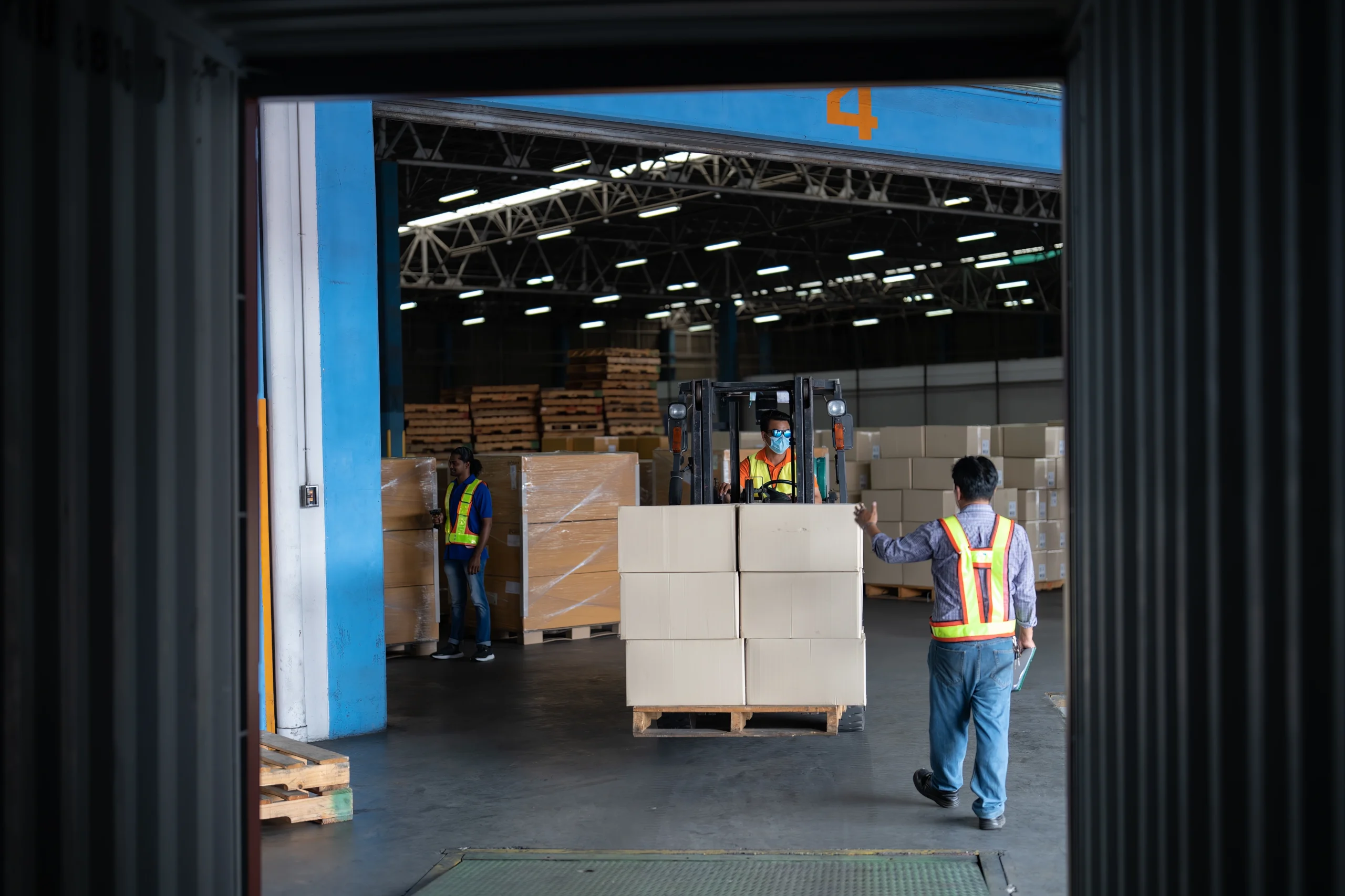 Forklift operator moving cargo pallets inside a Foreign Trade Zone warehouse, demonstrating streamlined storage and inventory management.