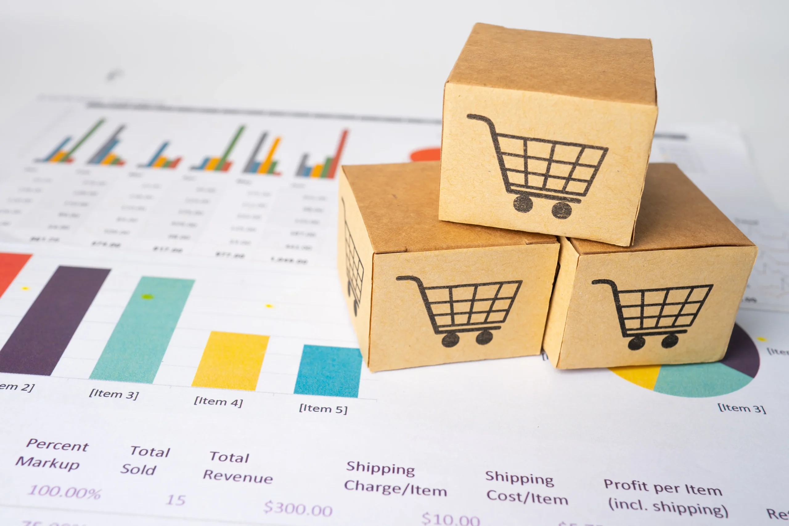Boxes with shopping cart logos placed on a graph chart, symbolizing e-commerce distribution and data analytics.