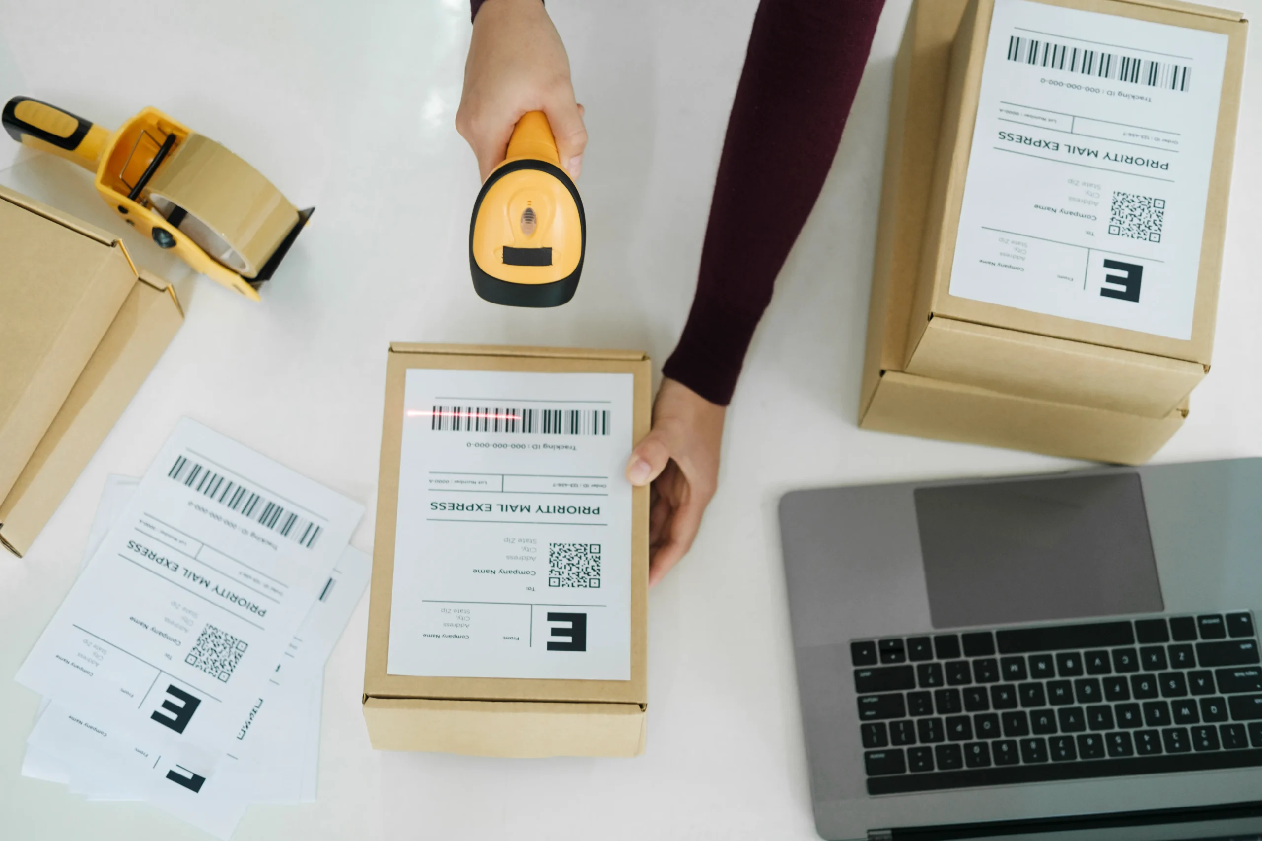 A warehouse worker scanning a barcode label on a package, demonstrating the efficiency of linear barcode types in logistics.