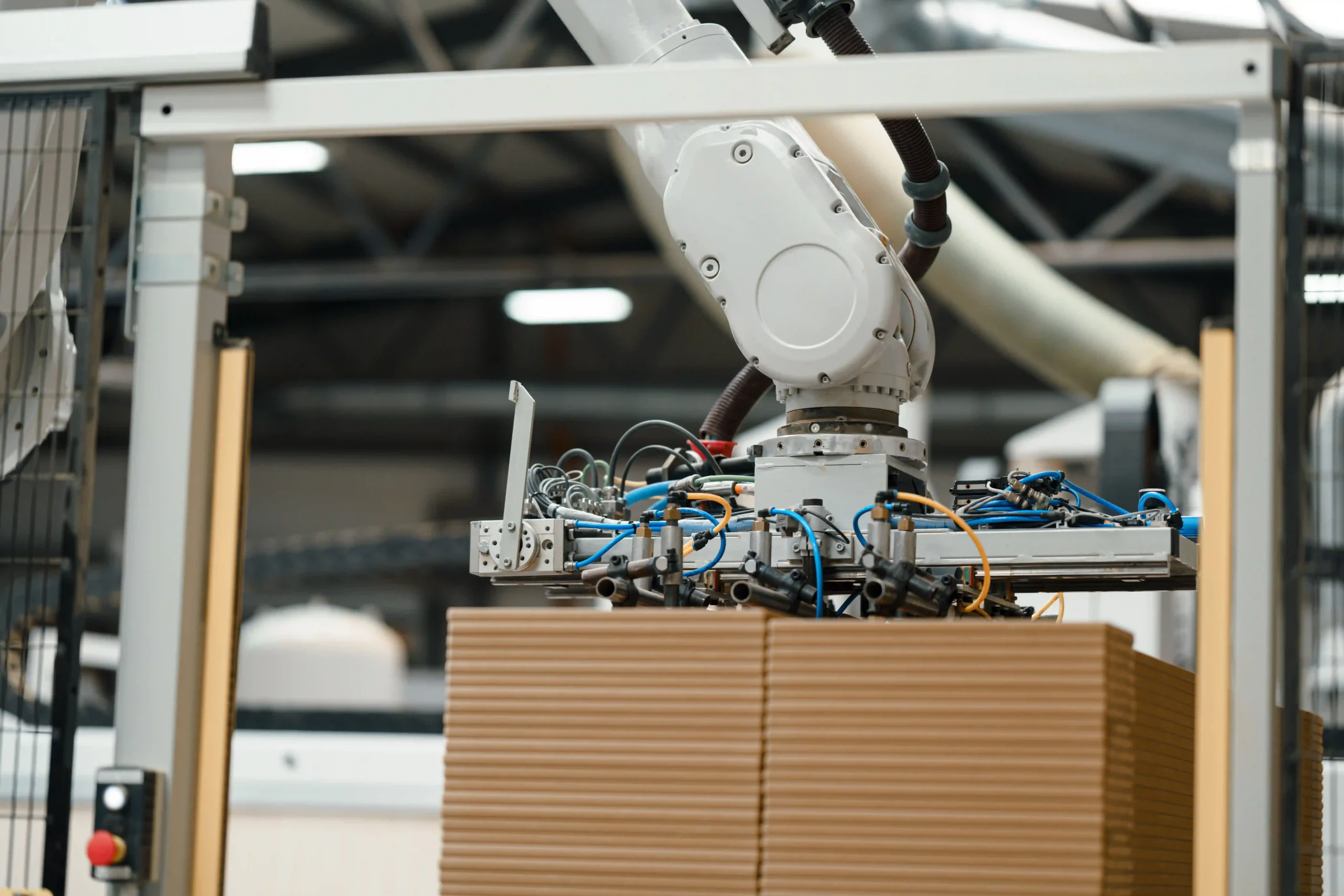 Close-up of a robotic arm stacking boxes on a pallet, demonstrating precision and efficiency in warehouse automation.