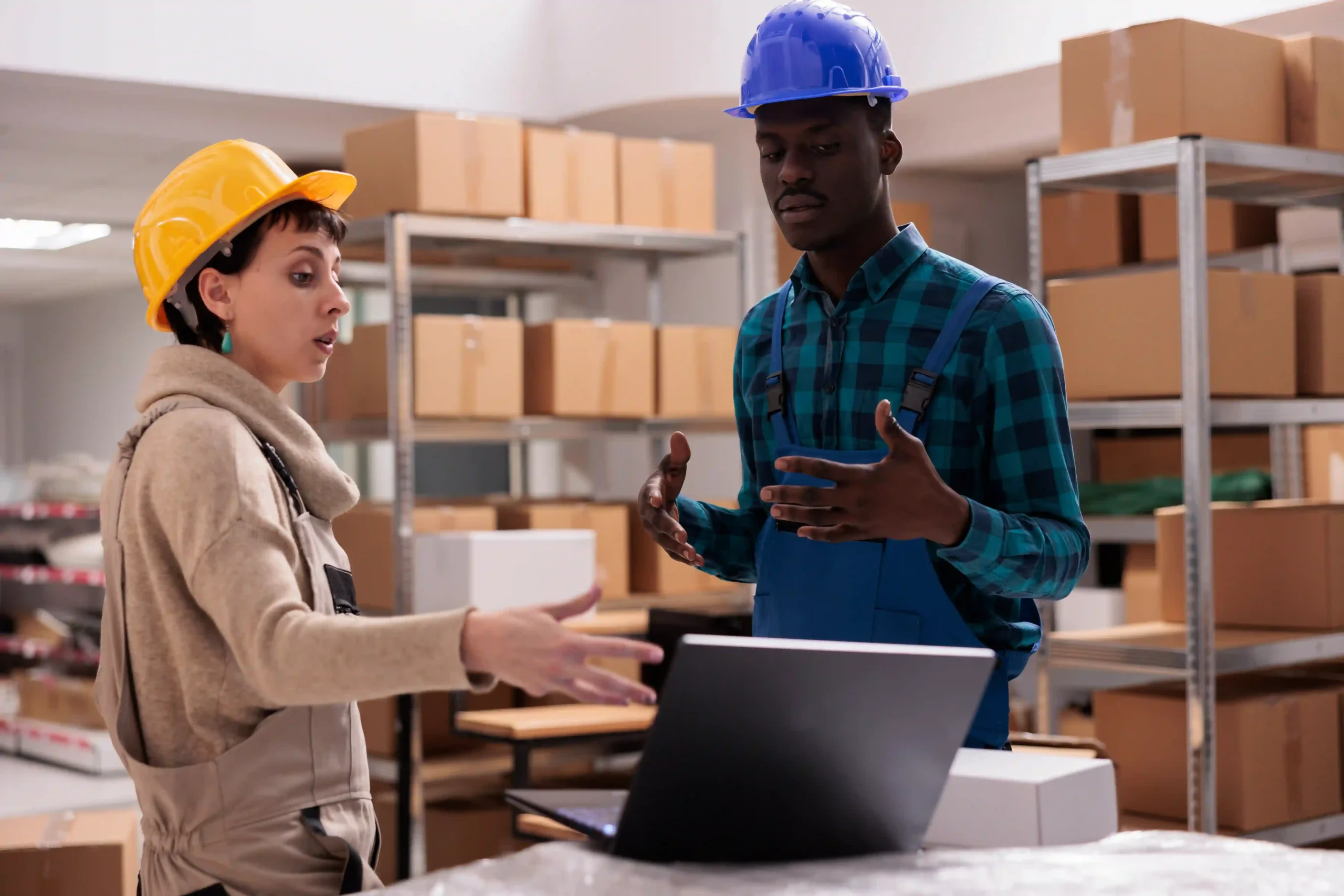 Retail warehouse managers reviewing orders using cross docking software to streamline inventory management.