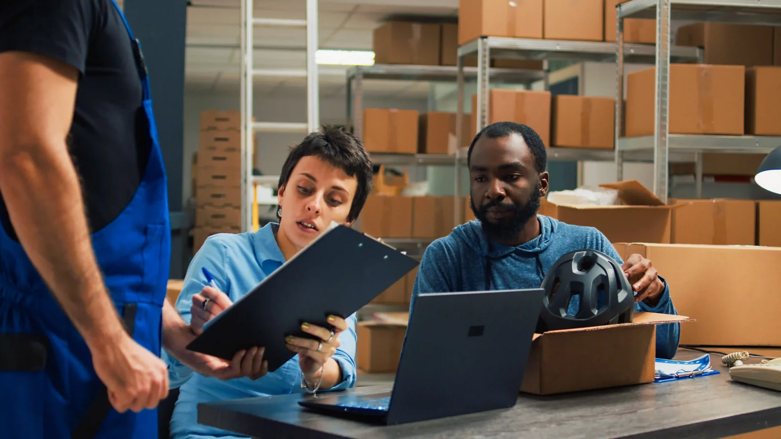 Small business team using an inventory management system list to fulfill online orders efficiently.
