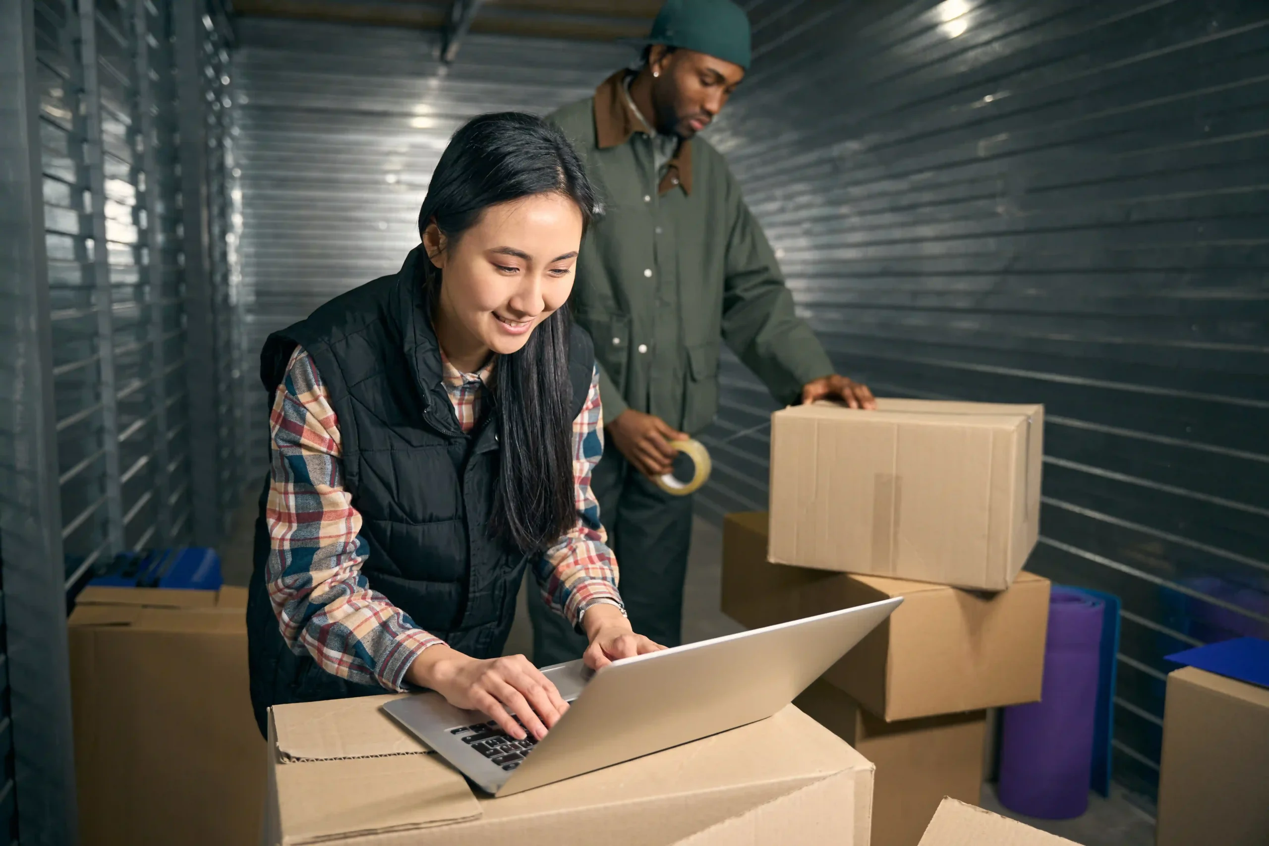 Warehouse employees preparing goods for shipment using cross docking software for efficient distribution.