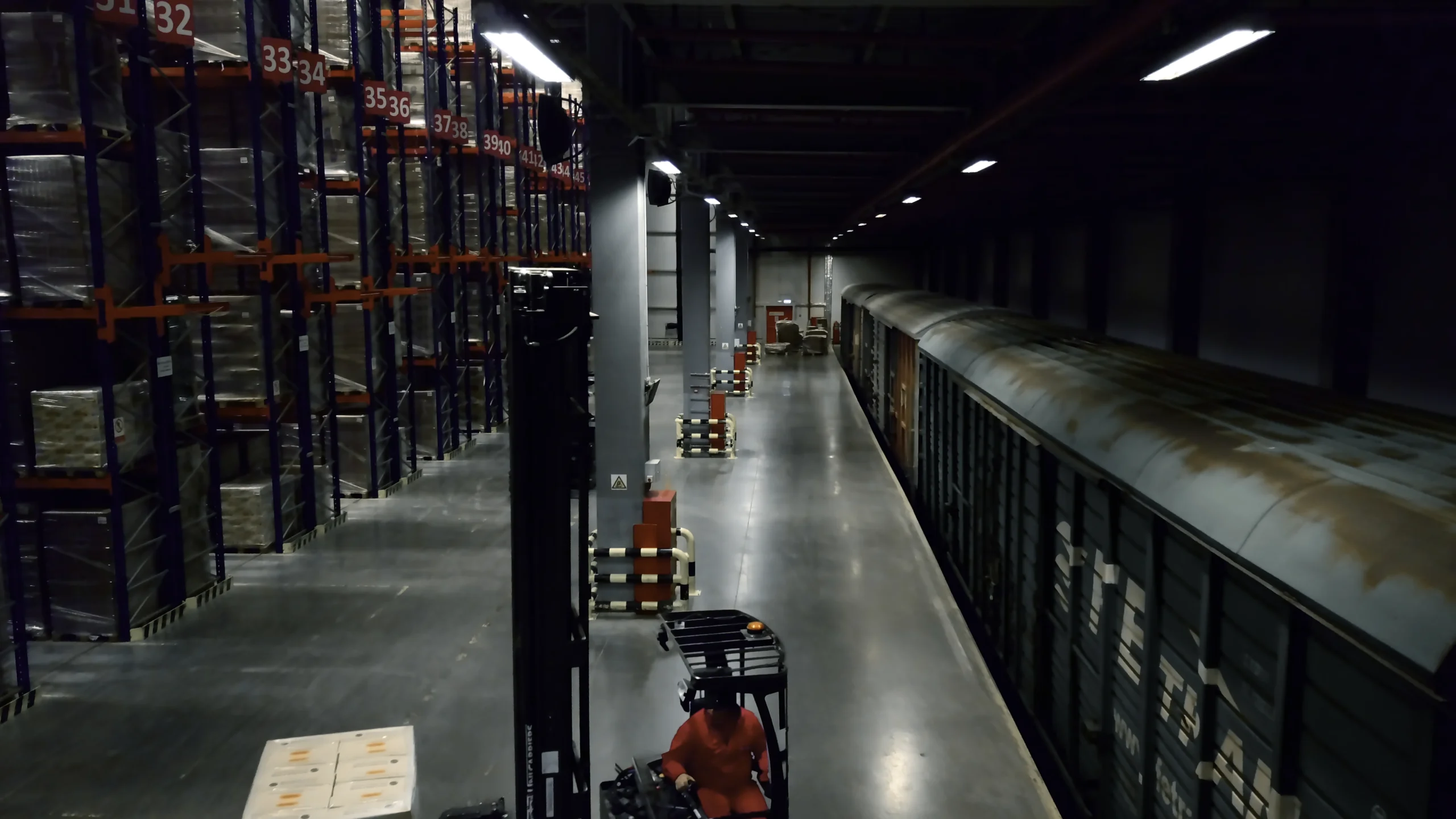 A cross docking distribution center unloading freight trains, ensuring smooth transition from rail to outbound transportation.