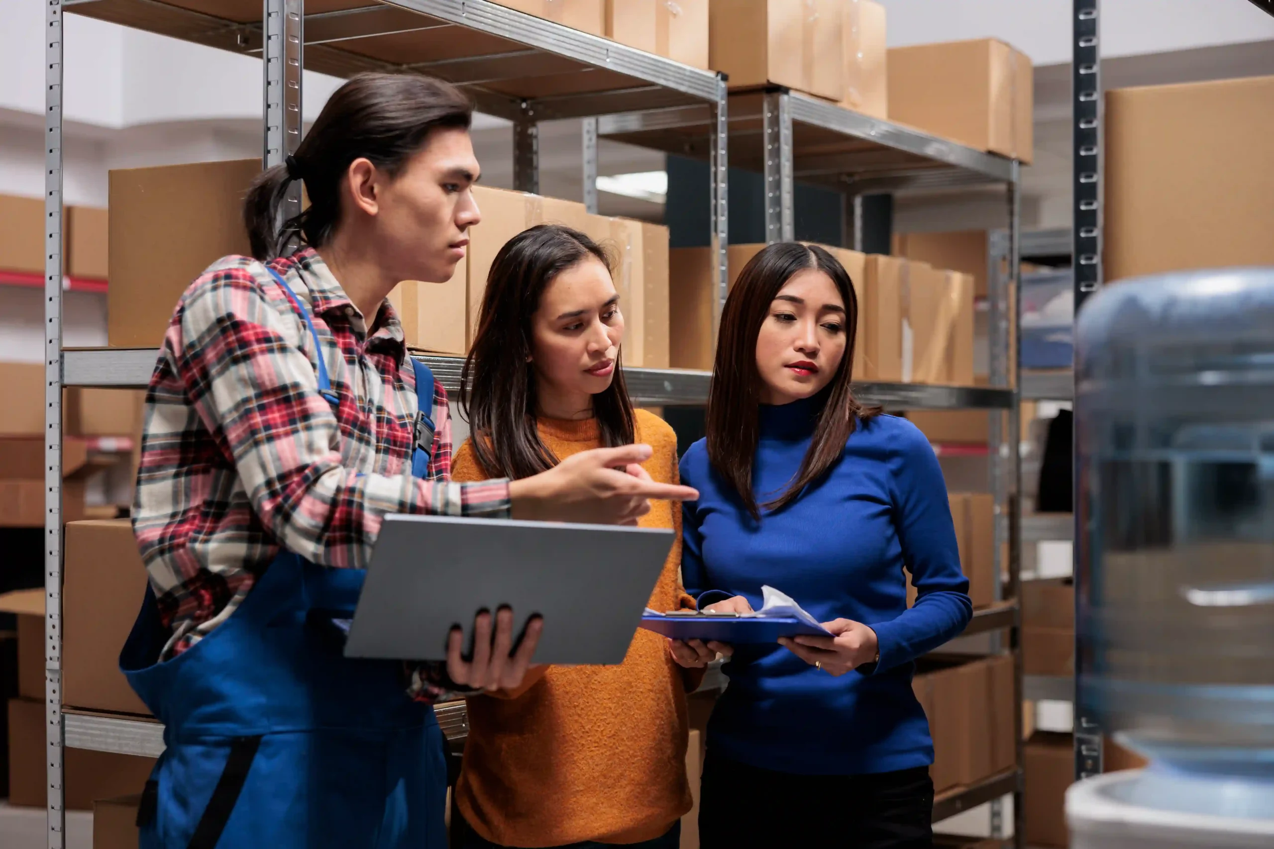 Warehouse employees preparing an order using a pick-ticket system, optimizing efficiency through an inventory management system use case.