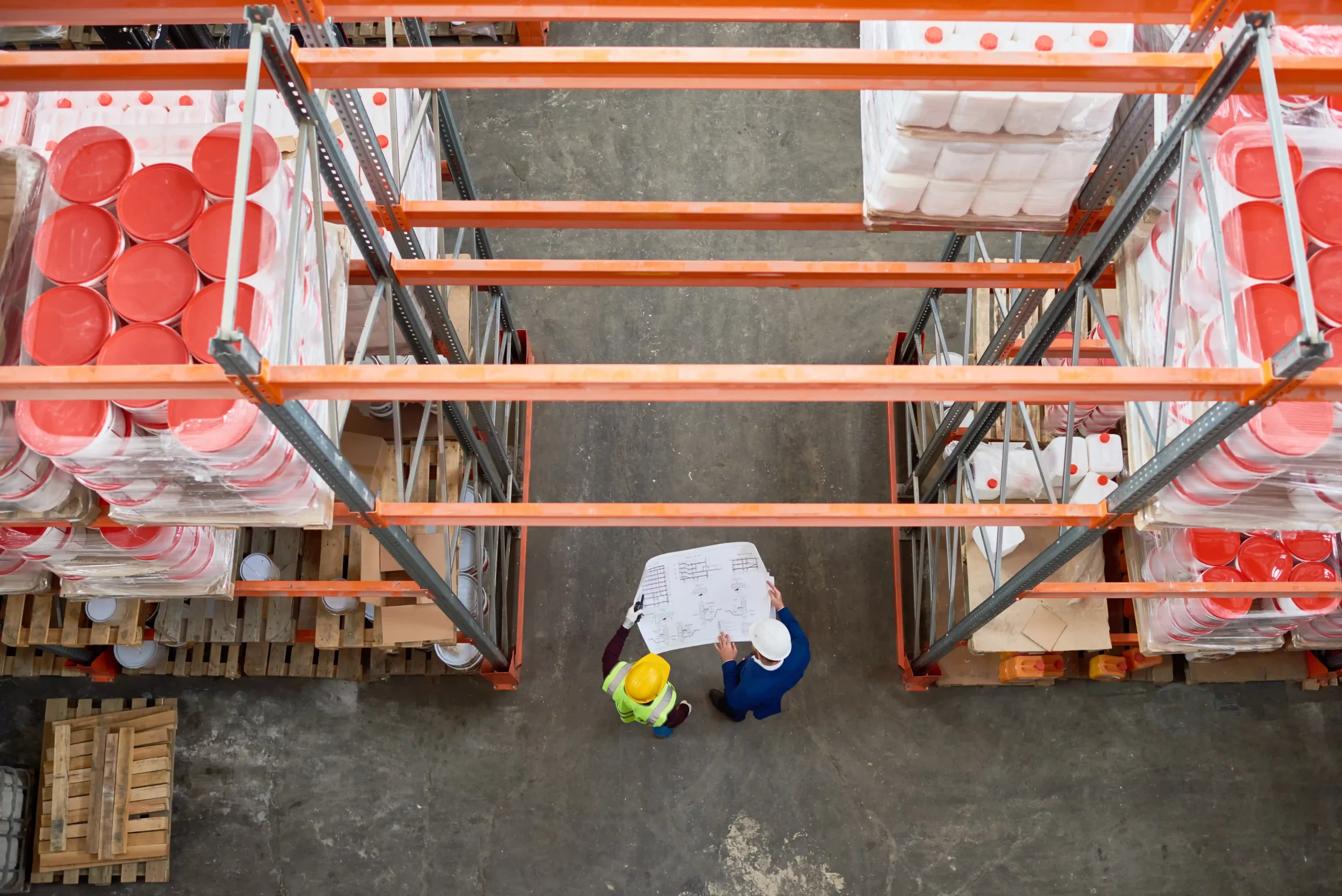 Warehouse workers discussing storage plans in a facility optimized for dedicated saline storage.