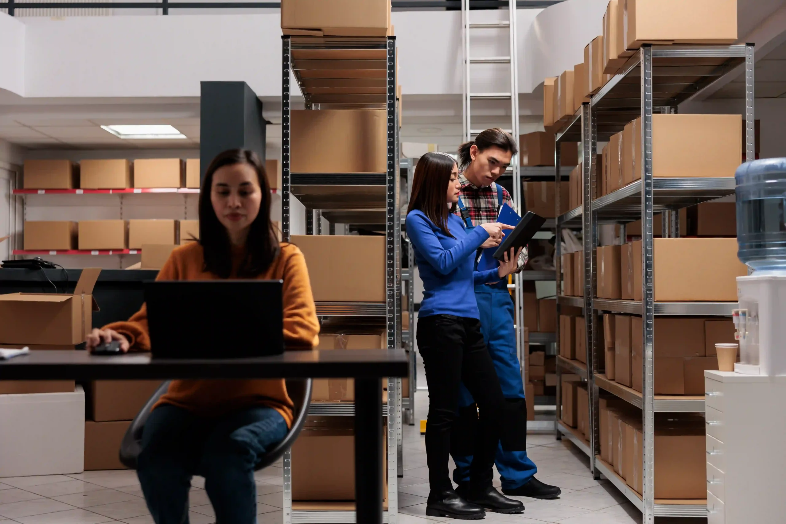 Warehouse team managing inventory with an inventory management system report, ensuring accurate stock tracking and efficient fulfillment.