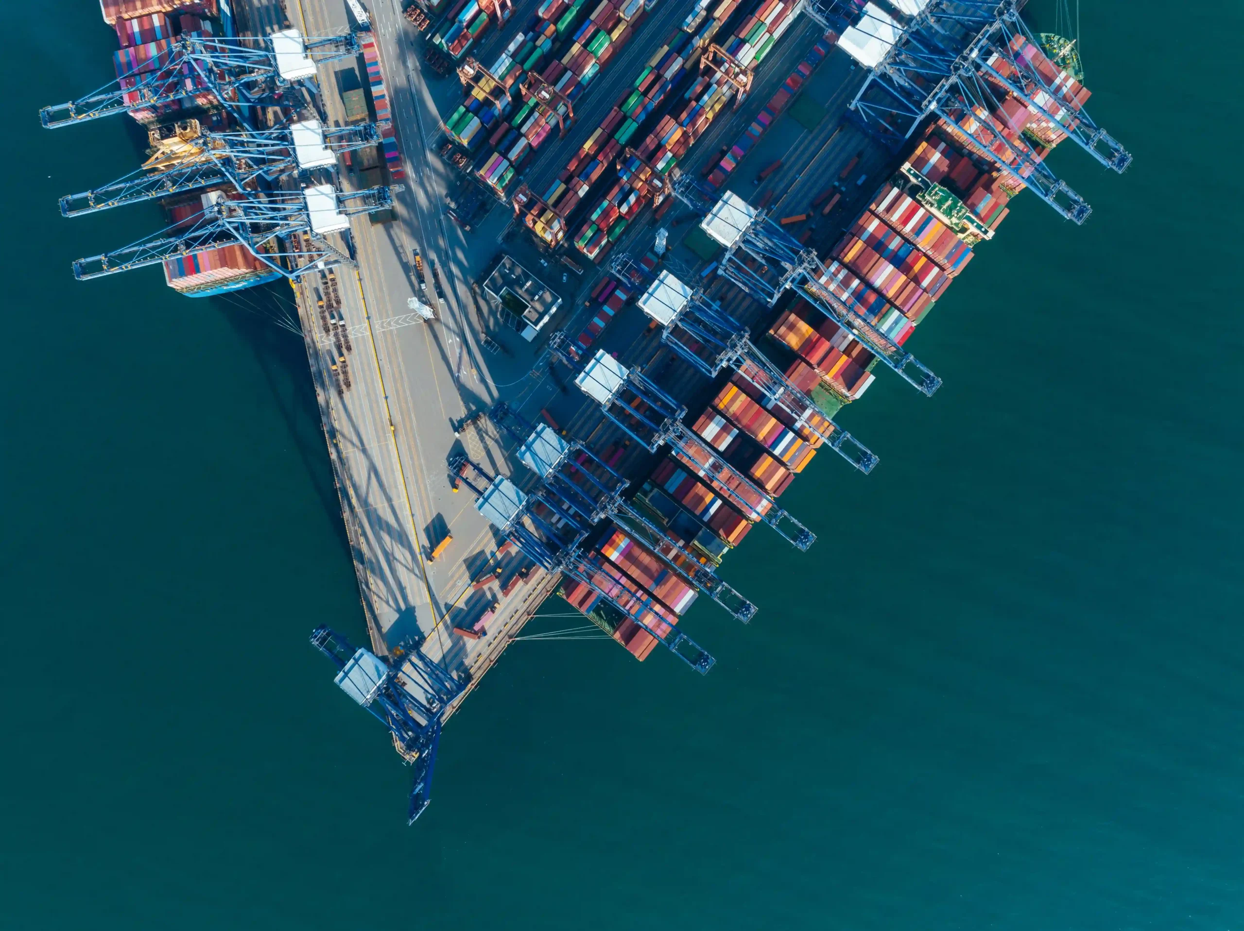 Aerial view of a busy container terminal showcasing global trade logistics and supply chain optimization challenges.
