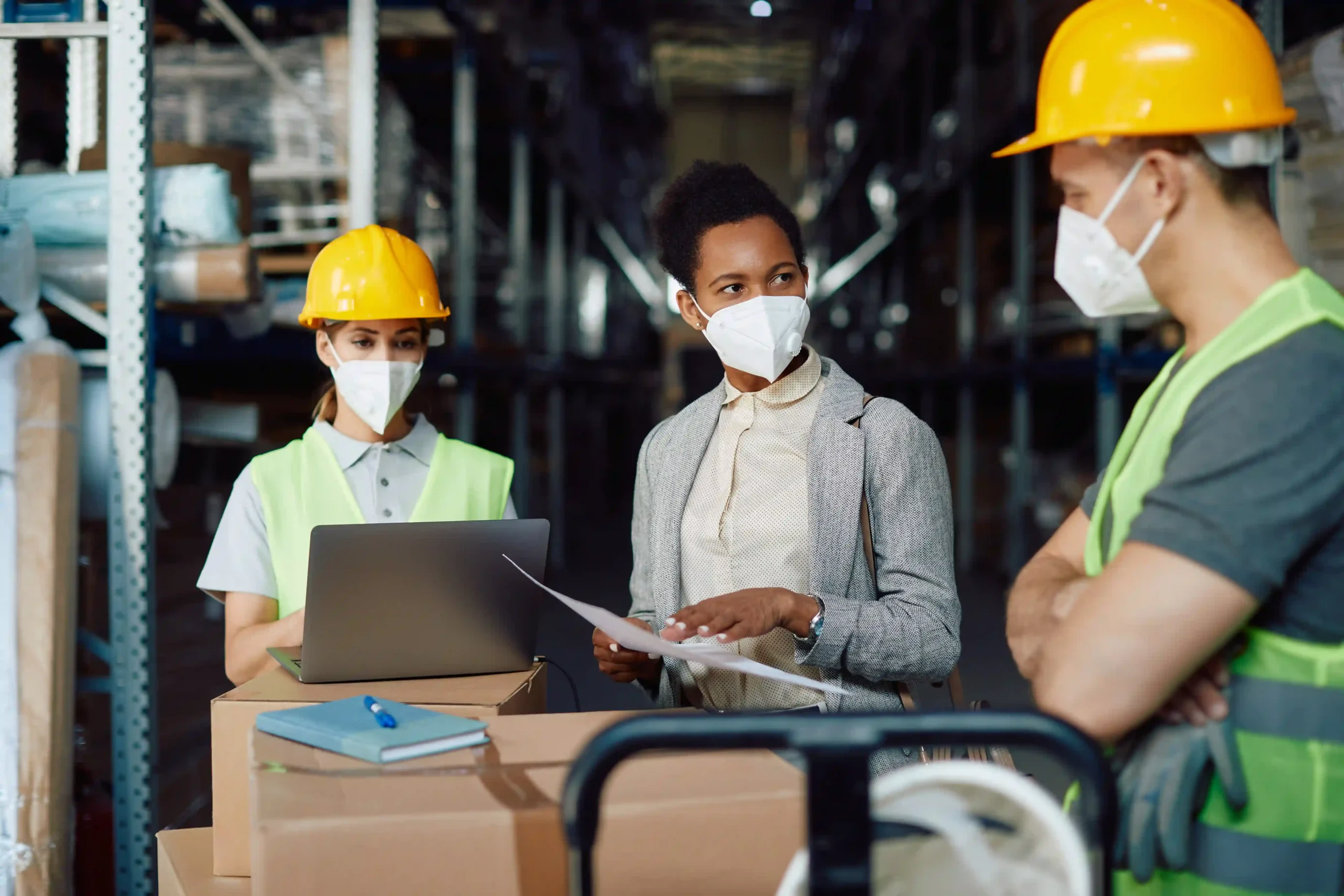 A logistics supervisor discussing real-time supply chain optimization with warehouse workers, ensuring seamless operations.