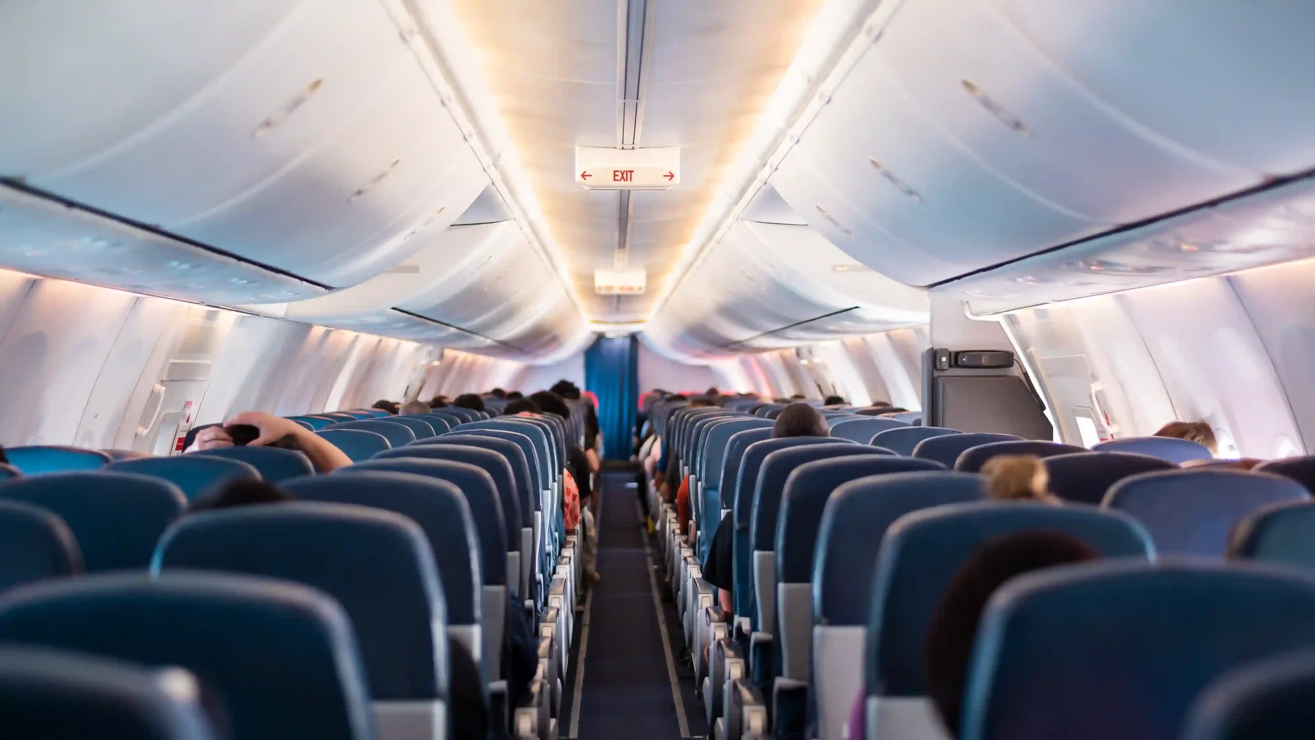 A view of passengers seated in an airplane cabin, representing the changing dynamics of the airline industry today.