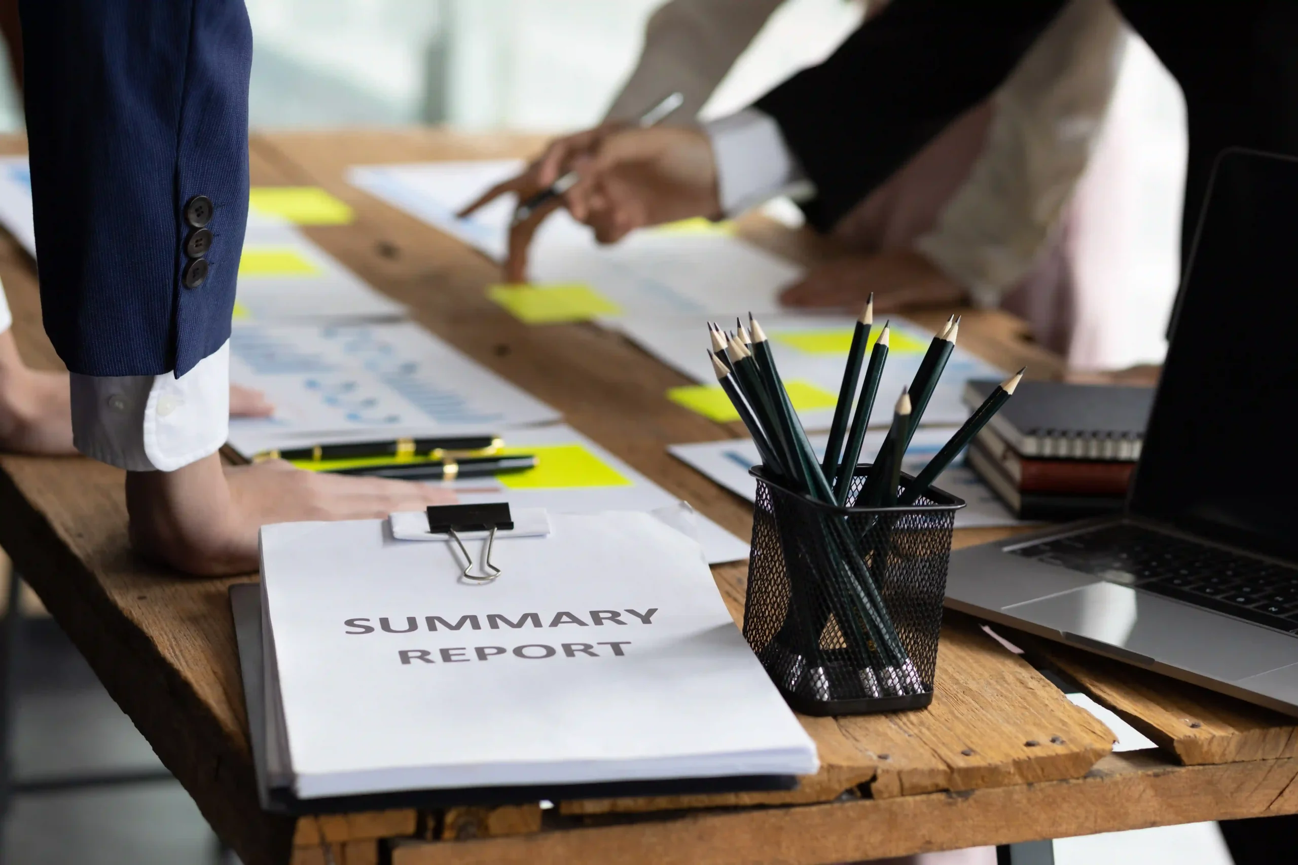 Business professionals analyzing custom report types at a strategy meeting, reviewing data insights for logistics optimization.
