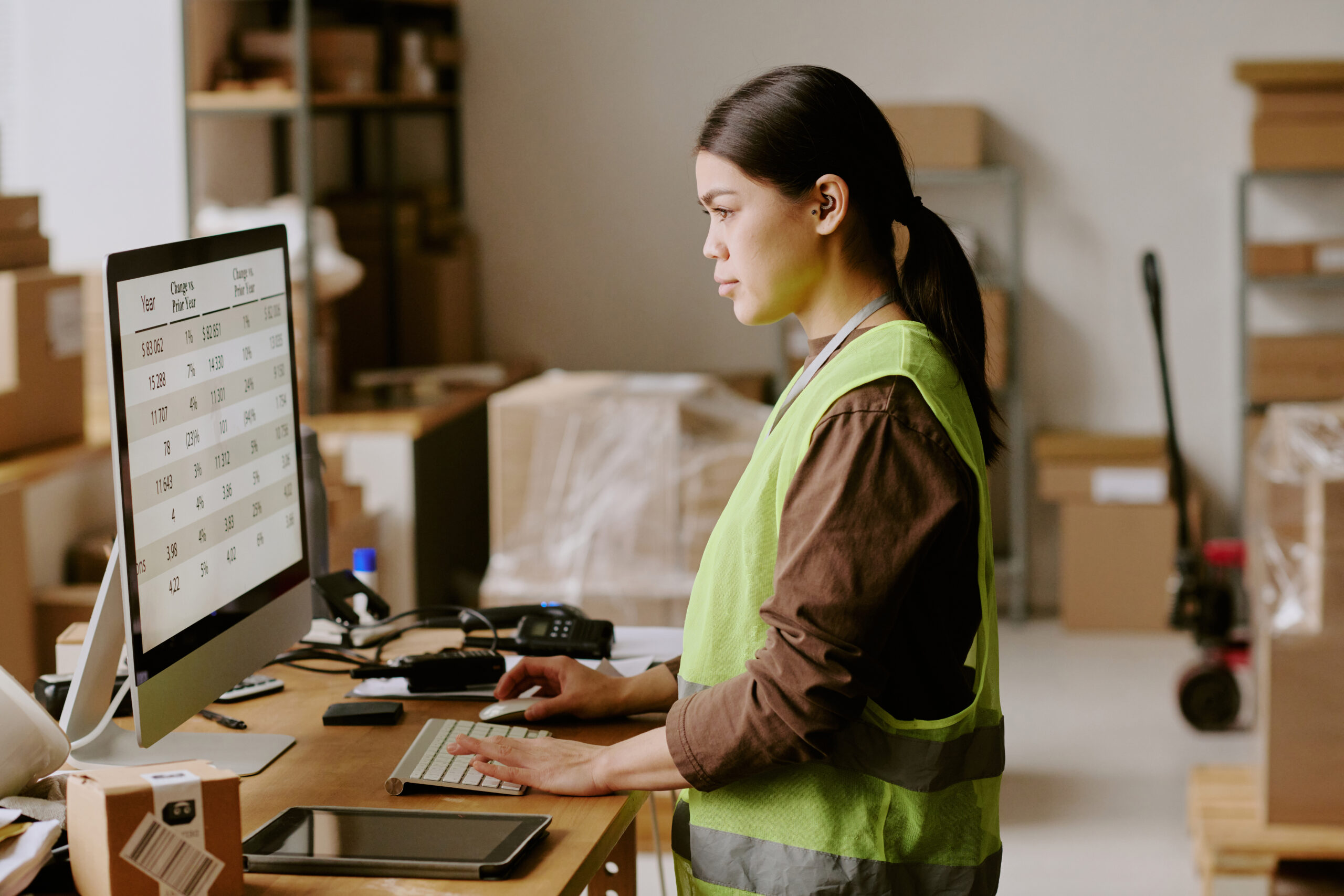 A businesswoman reviewing financial and operational reports using custom report writing software for data-driven decision-making.