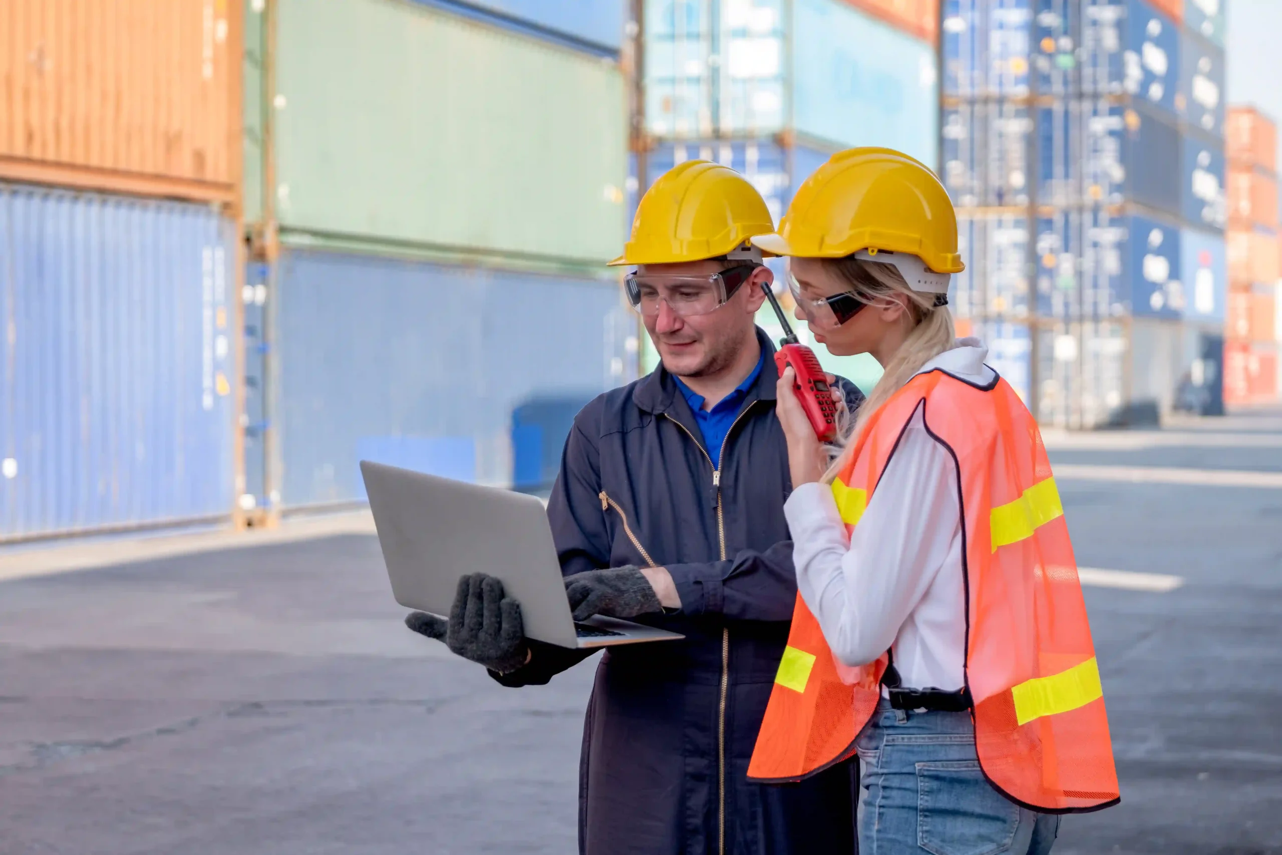 Logistics professionals reviewing compliance requirements for the FTZ certification and setup process at an industrial site.
