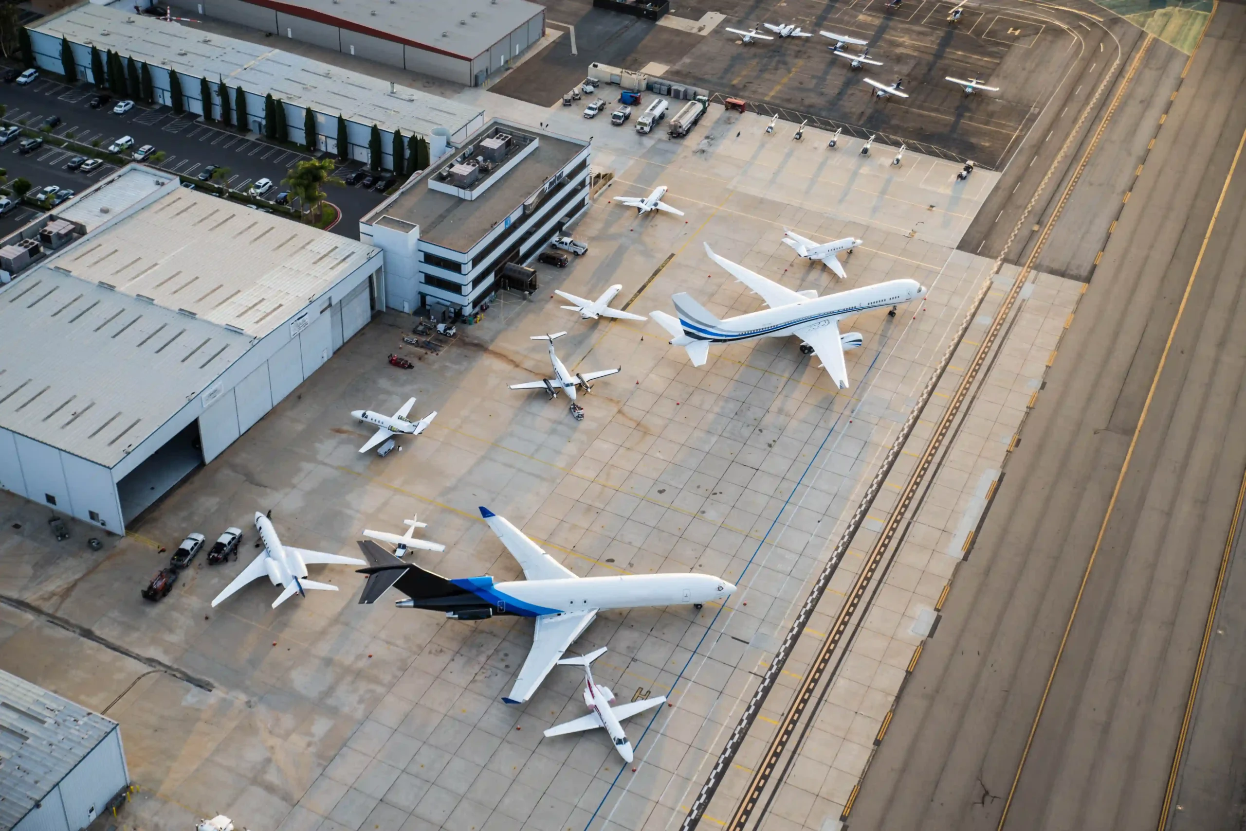 A busy airport tarmac with multiple airplanes, representing air travel demand and logistics in the airline industry today.