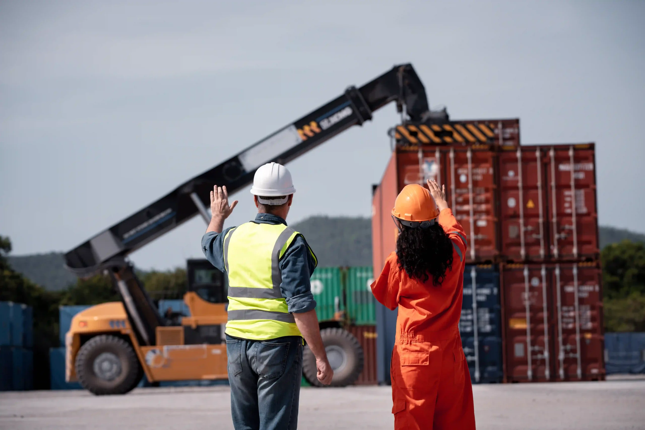Workers at a third-party logistics 3PL services provider managing freight operations at a container yard.