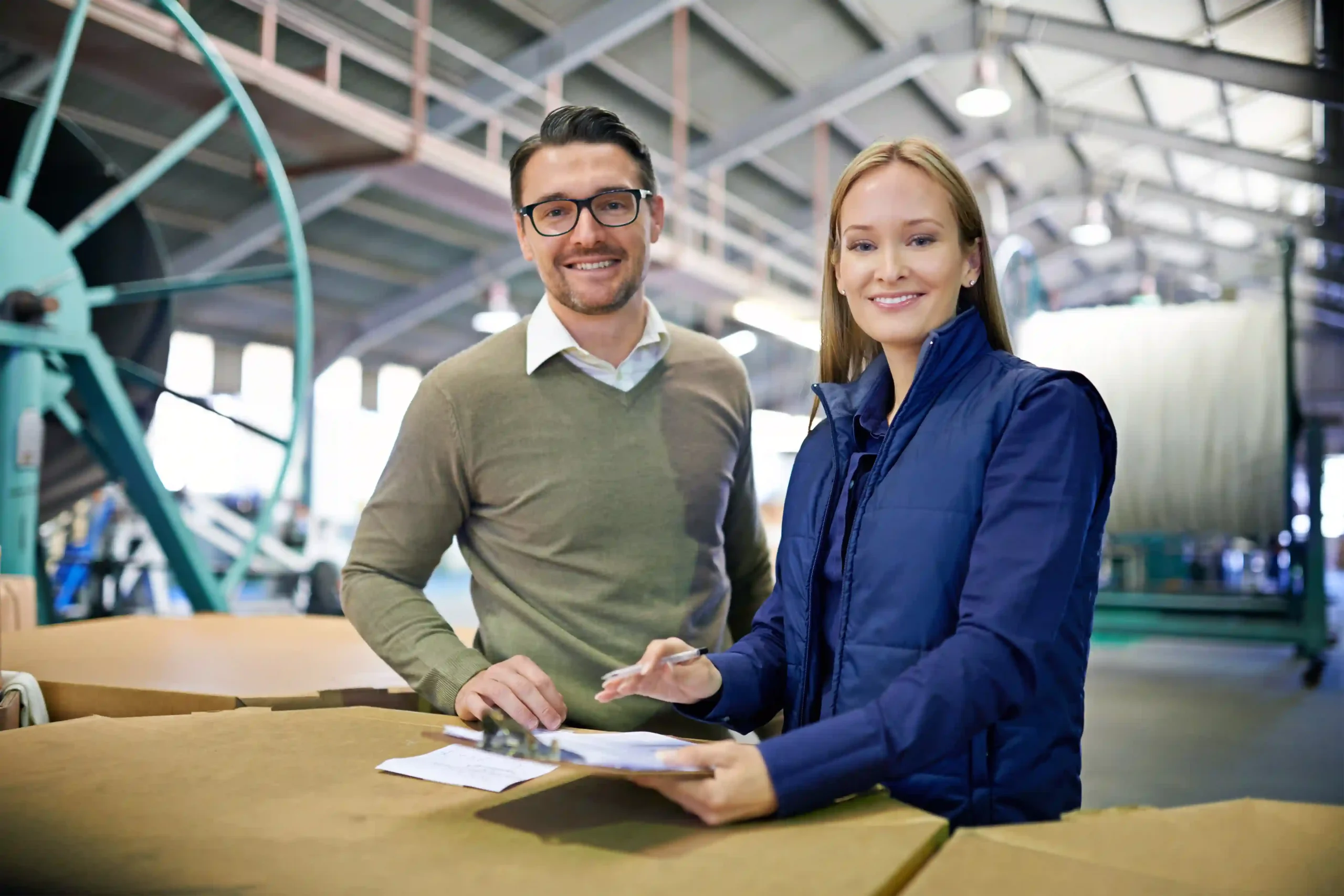 Two warehouse managers discussing FTZ certification and setup process while reviewing international shipping documents.