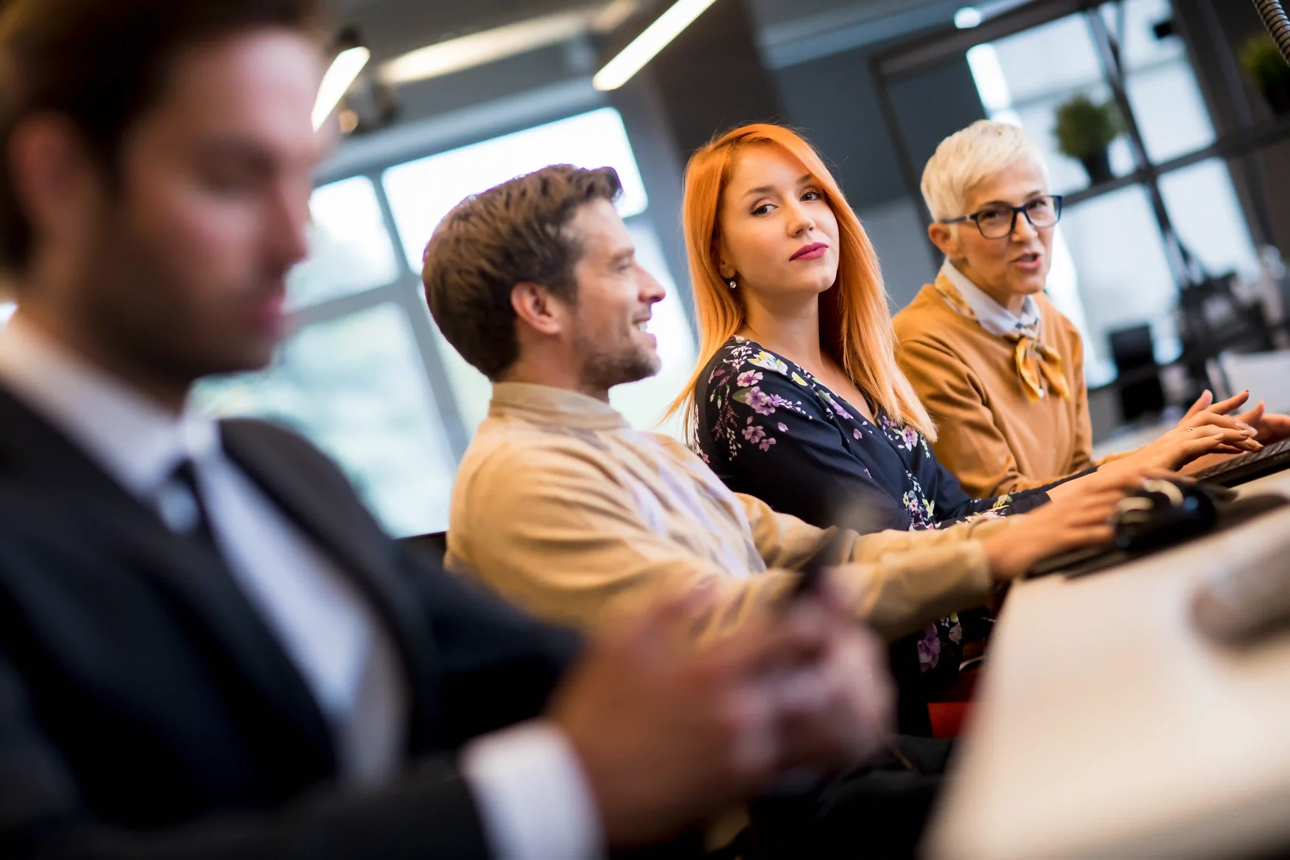 A group of business professionals engaged in a discussion in a modern office setting, analyzing environmental policies and regulations. The conversation focuses on the question: is EPA reliable in enforcing environmental laws?