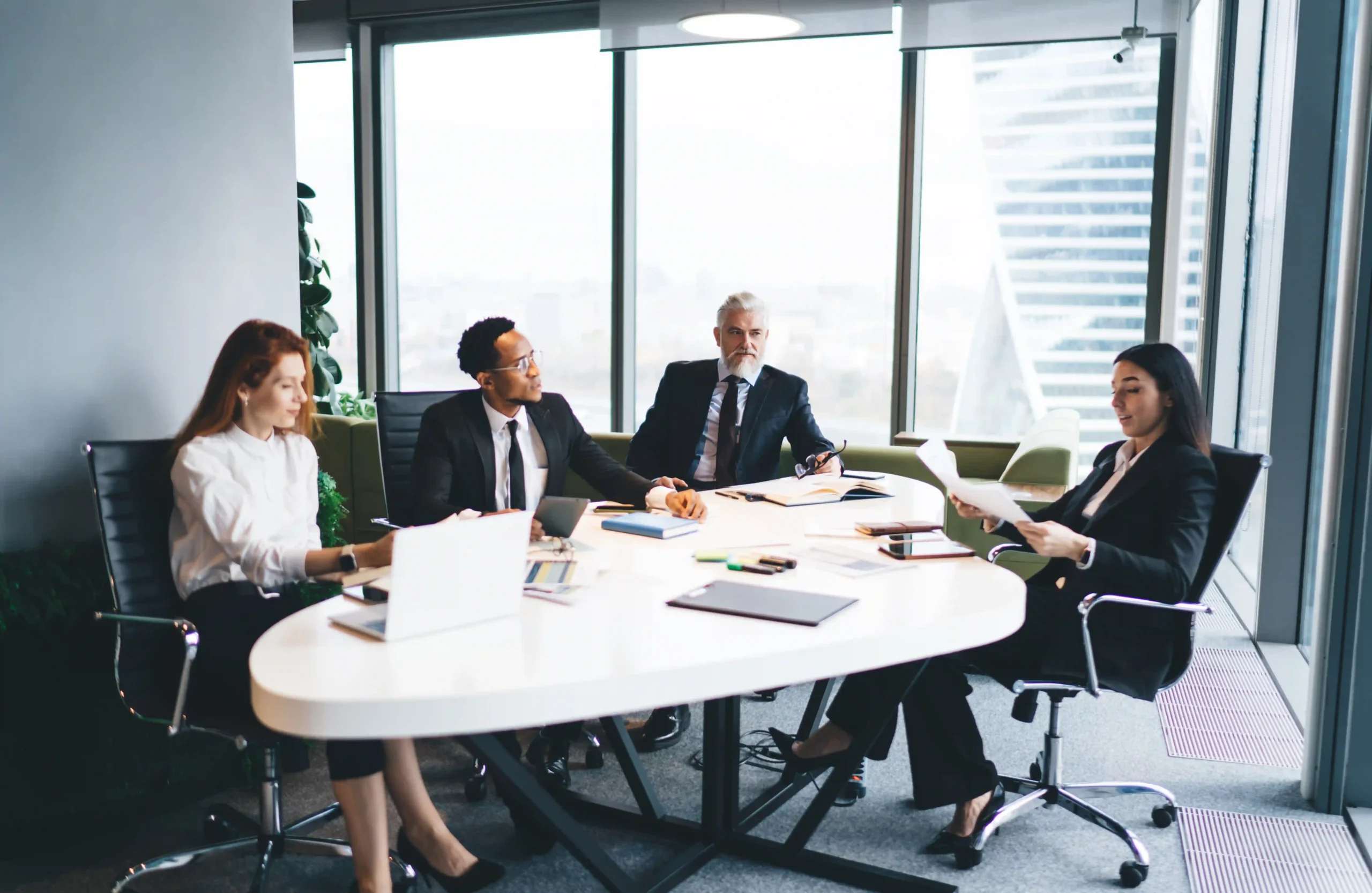 A team of business professionals listening to an expert explain compliance rules in regulated industries. Learn what are the most regulated industries.