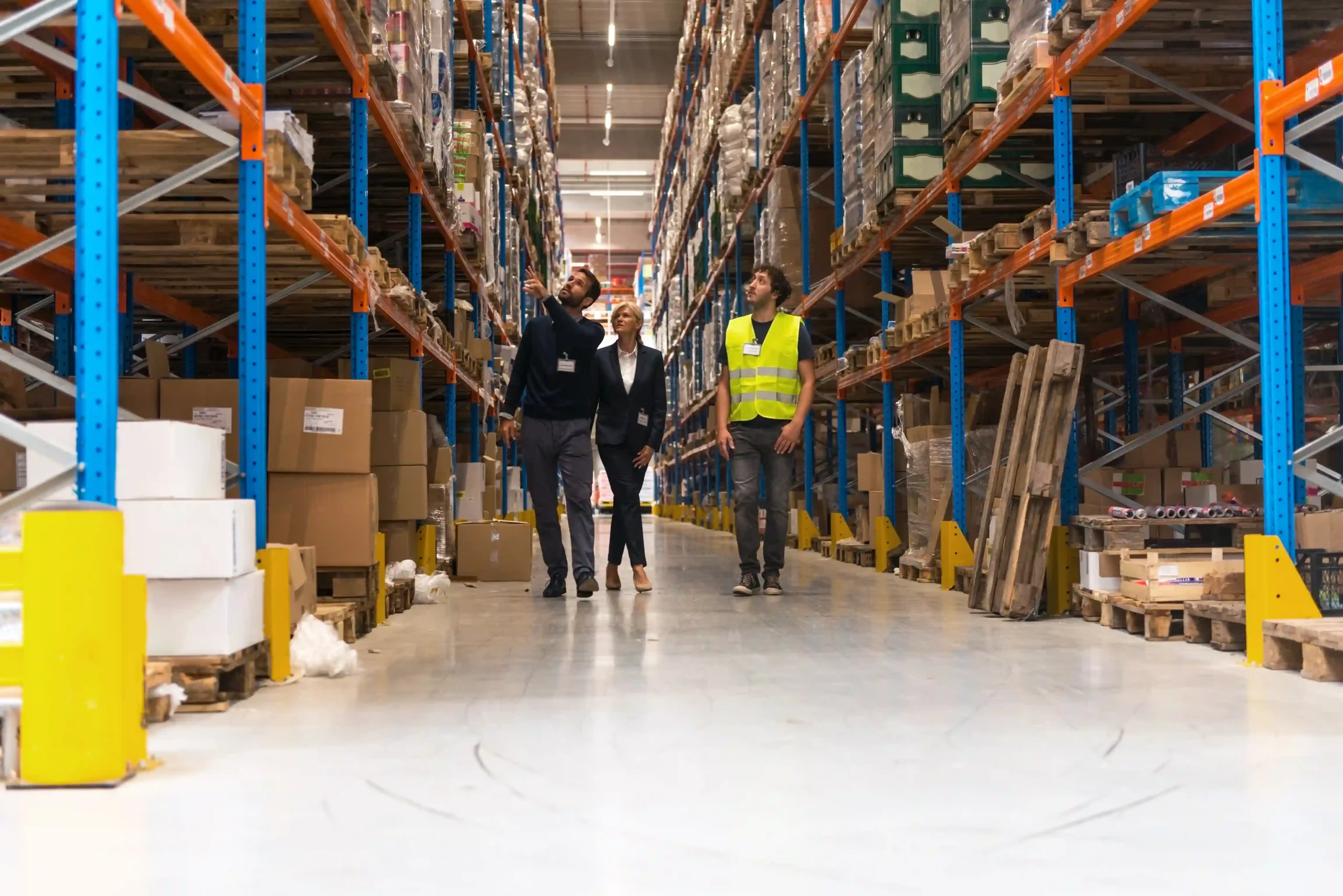 Managers and workers discussing FTZ warehouse operations in a well-organized facility.