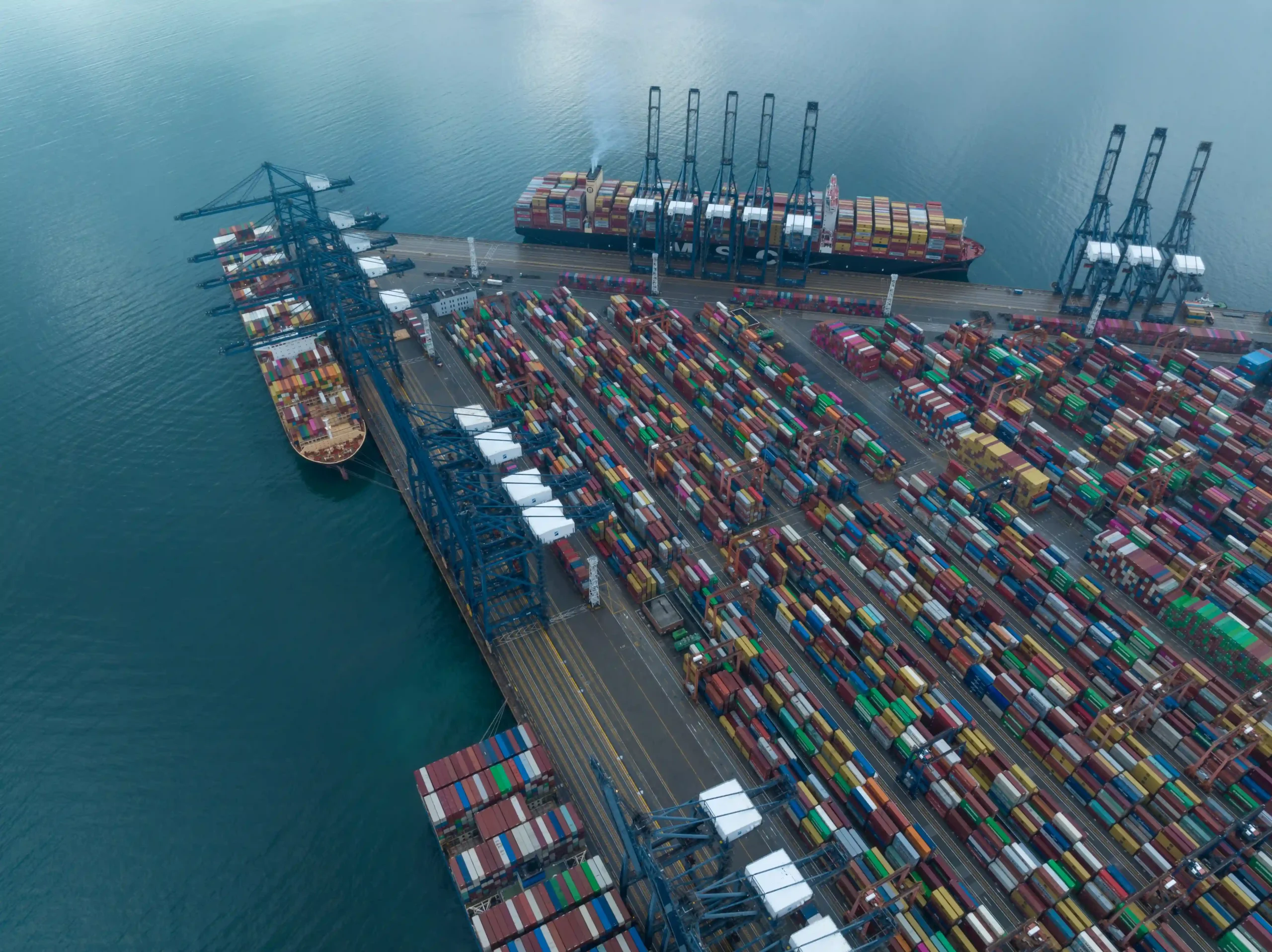 Aerial drone view of a major international shipping port, highlighting global trade strategies for dodging high tariffs.