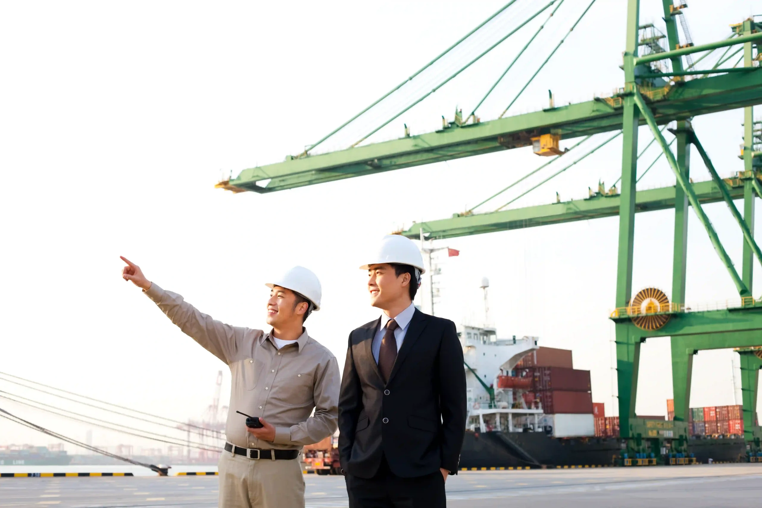 A shipping worker guiding a business leader through FTZ facilities, ensuring compliance with FTZ compliance requirements 2025.