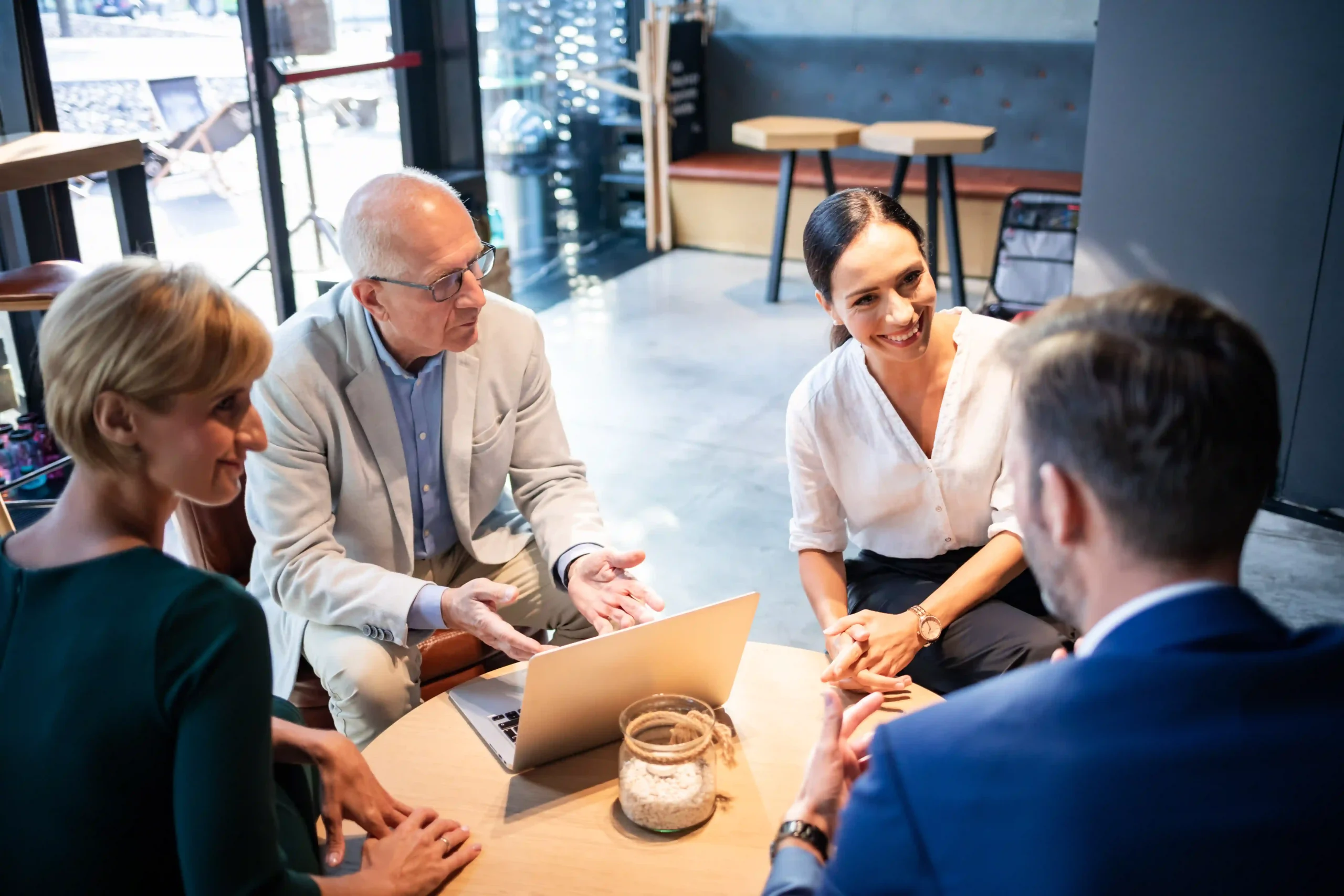 Small business owners reviewing EPA Labeling Manual requirements for product compliance over a business meeting.