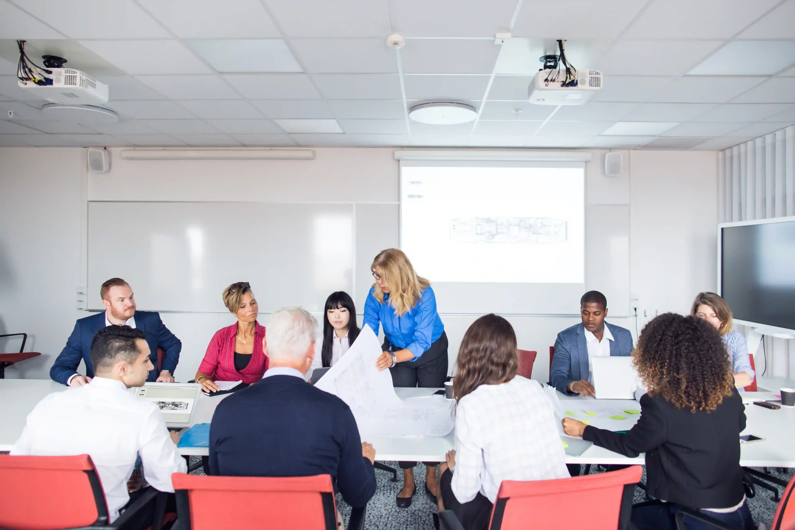 A team of architects and project managers collaborating on sustainable building strategies, debating is EPA reliable in regulating green construction practices.