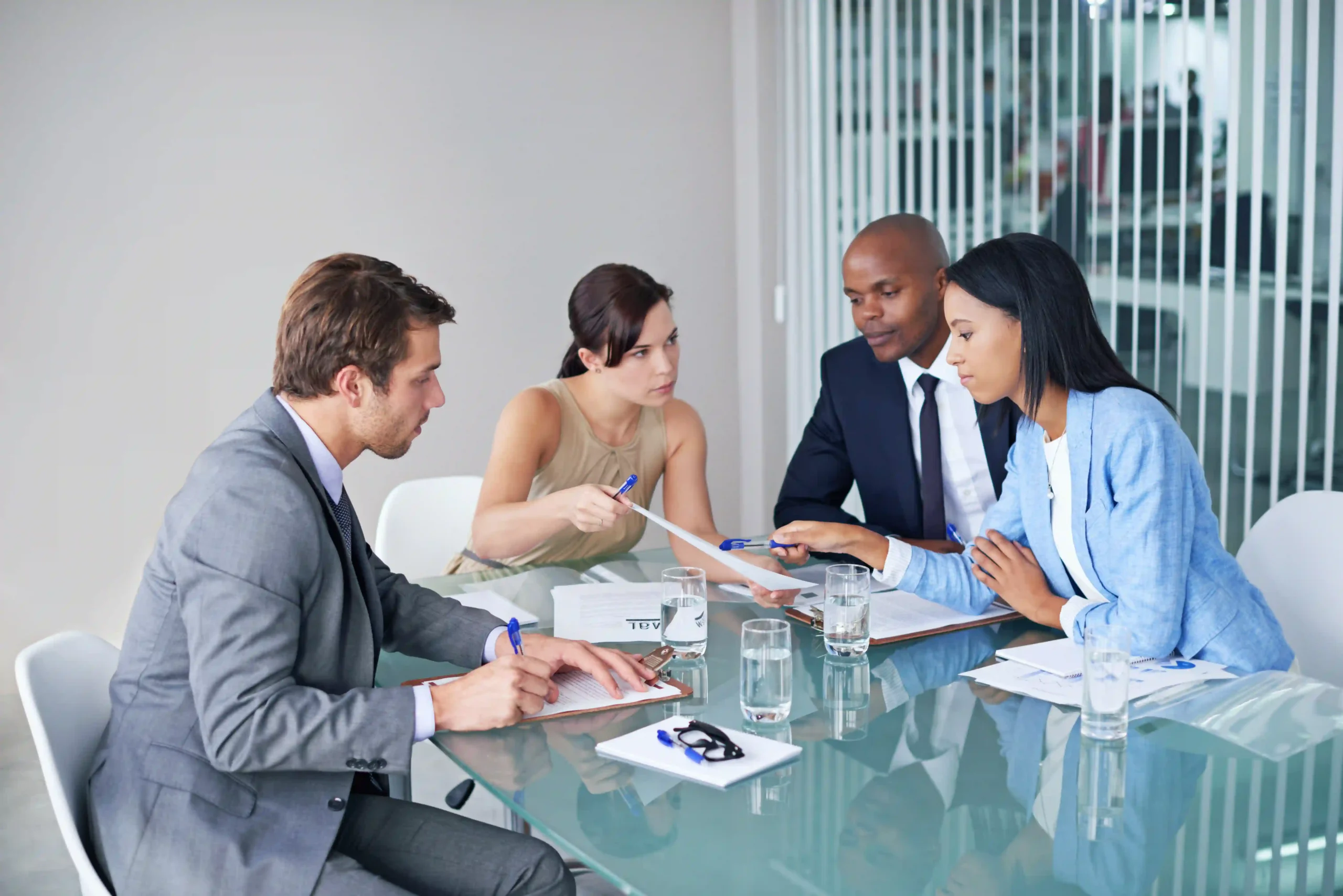 Diverse team analyzing FTZ cost savings strategies to optimize supply chain efficiency.
