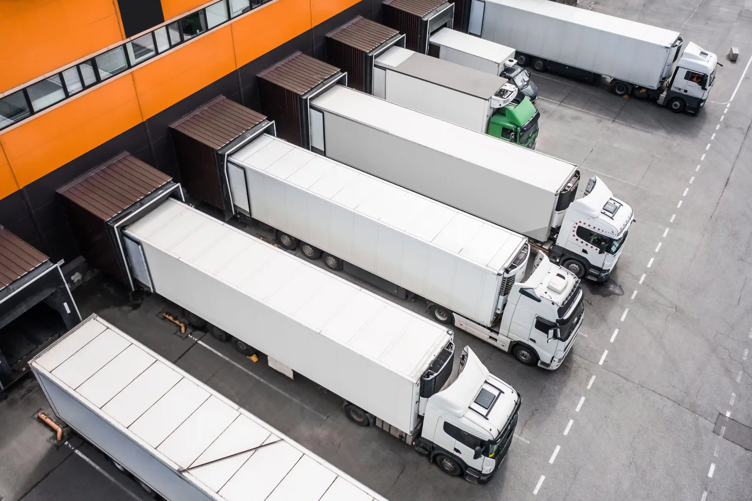 A fleet of trucks at a third-party logistics 3PL services provider’s distribution hub ready for shipment.