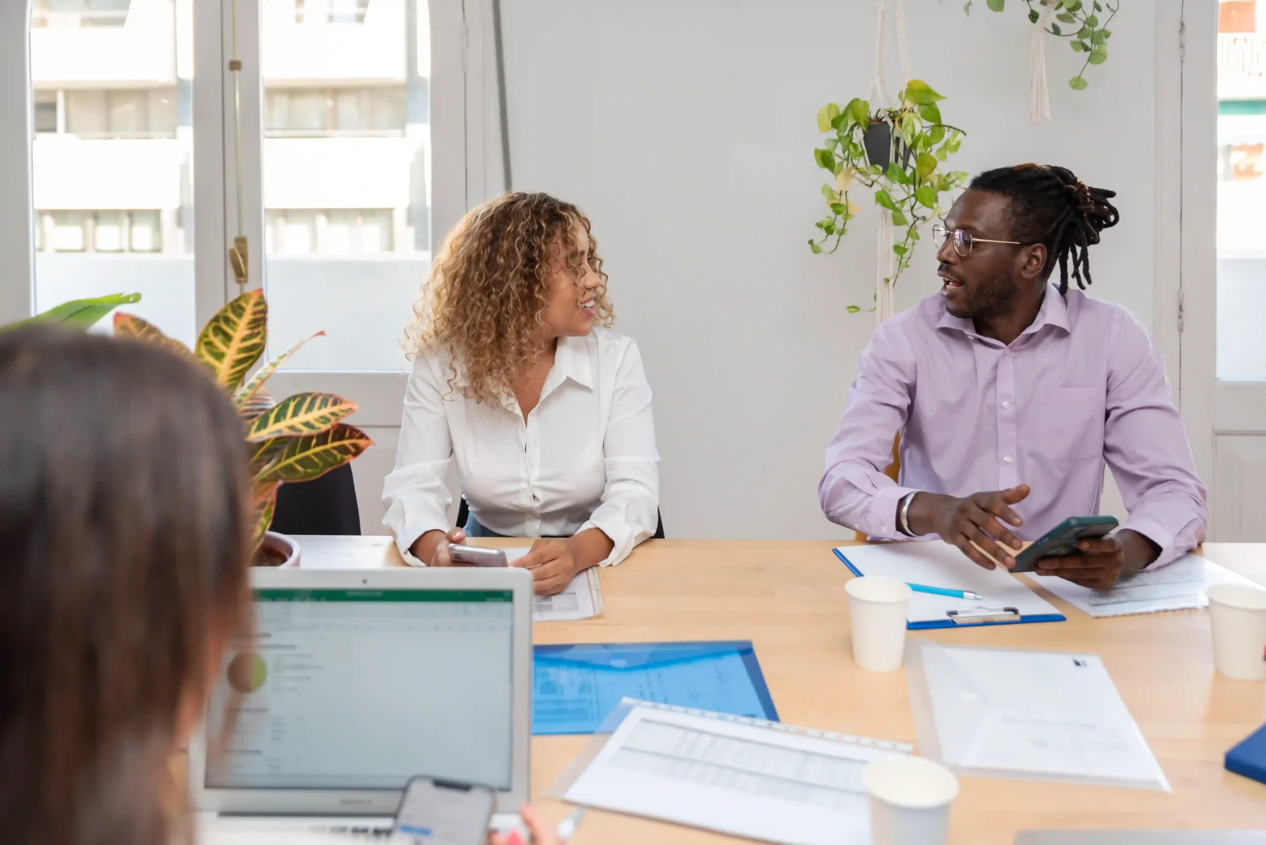 Two coworkers discussing FDA relabeler definition and its role in medical device compliance at an office table.