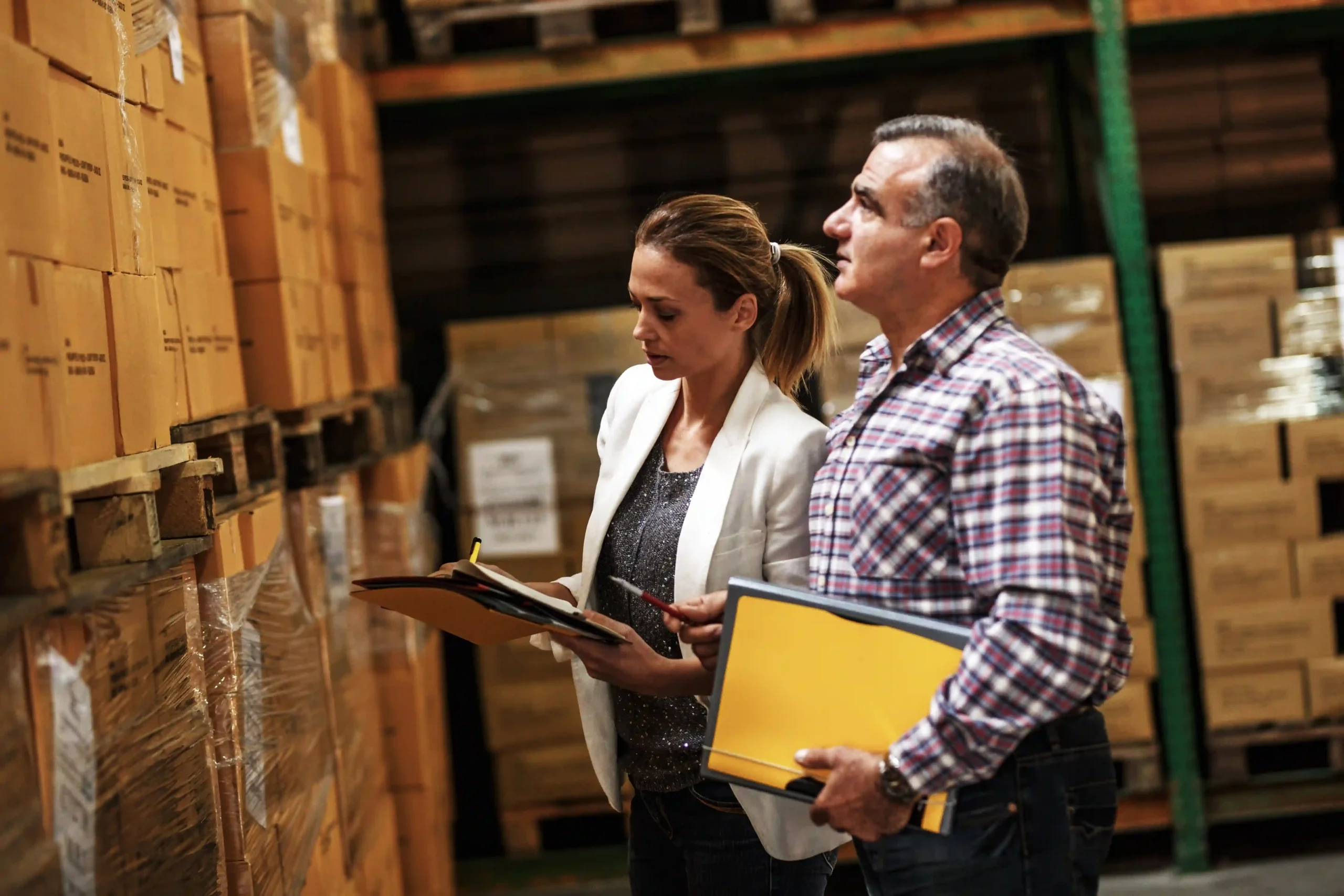 Supply chain experts inspecting warehouse stock for better visibility and optimization in global logistics.