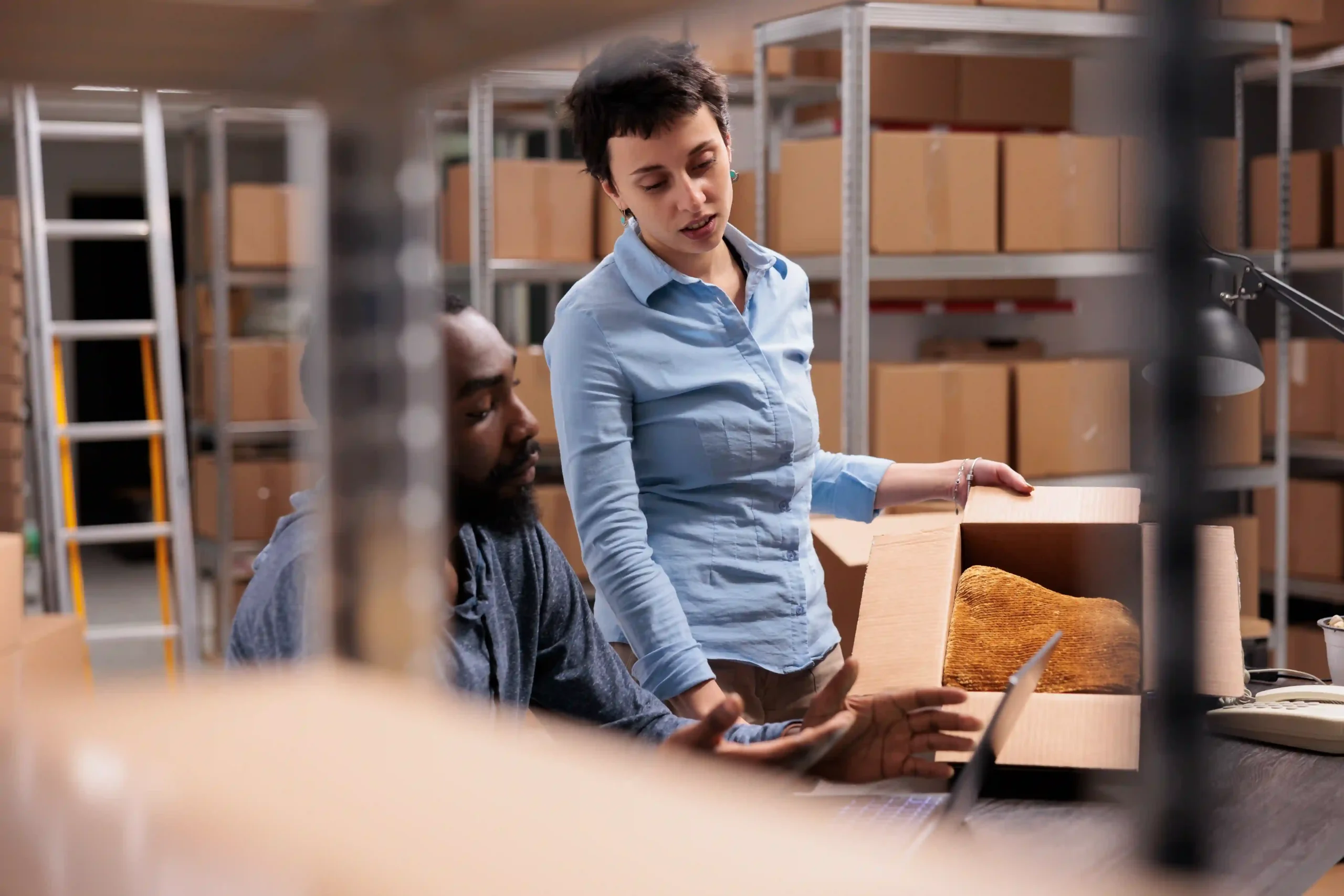 A warehouse supervisor demonstrating product handling efficiency, illustrating supply chain optimization meaning in real-time operations