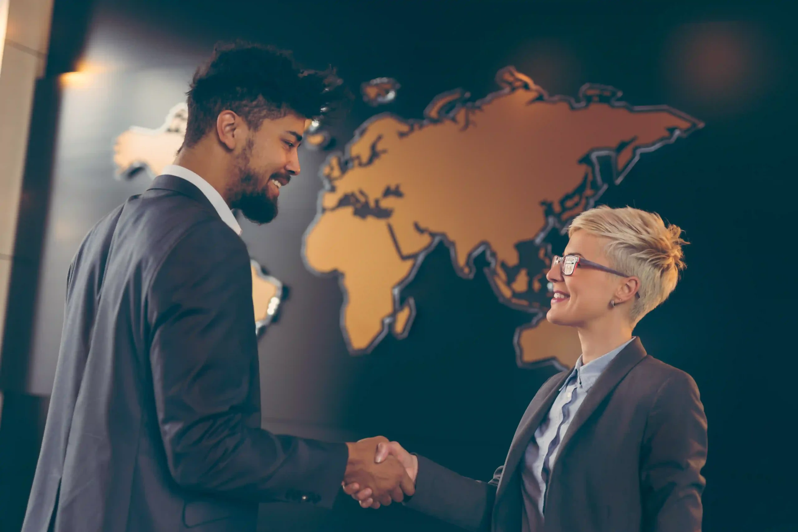Business professionals shaking hands after a successful global trade compliance certification agreement