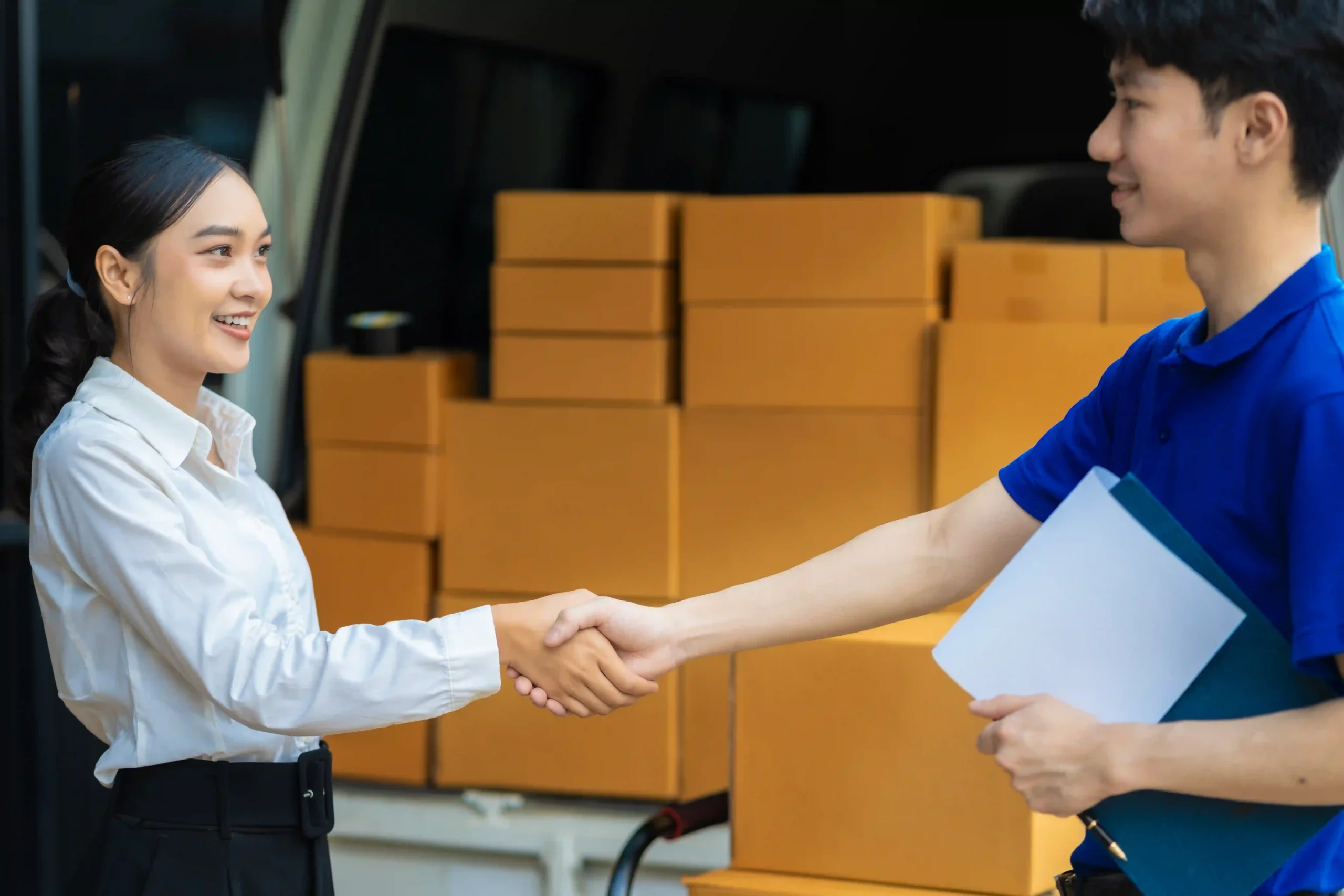 Business professionals sealing a 3PL contract logistics agreement with a handshake