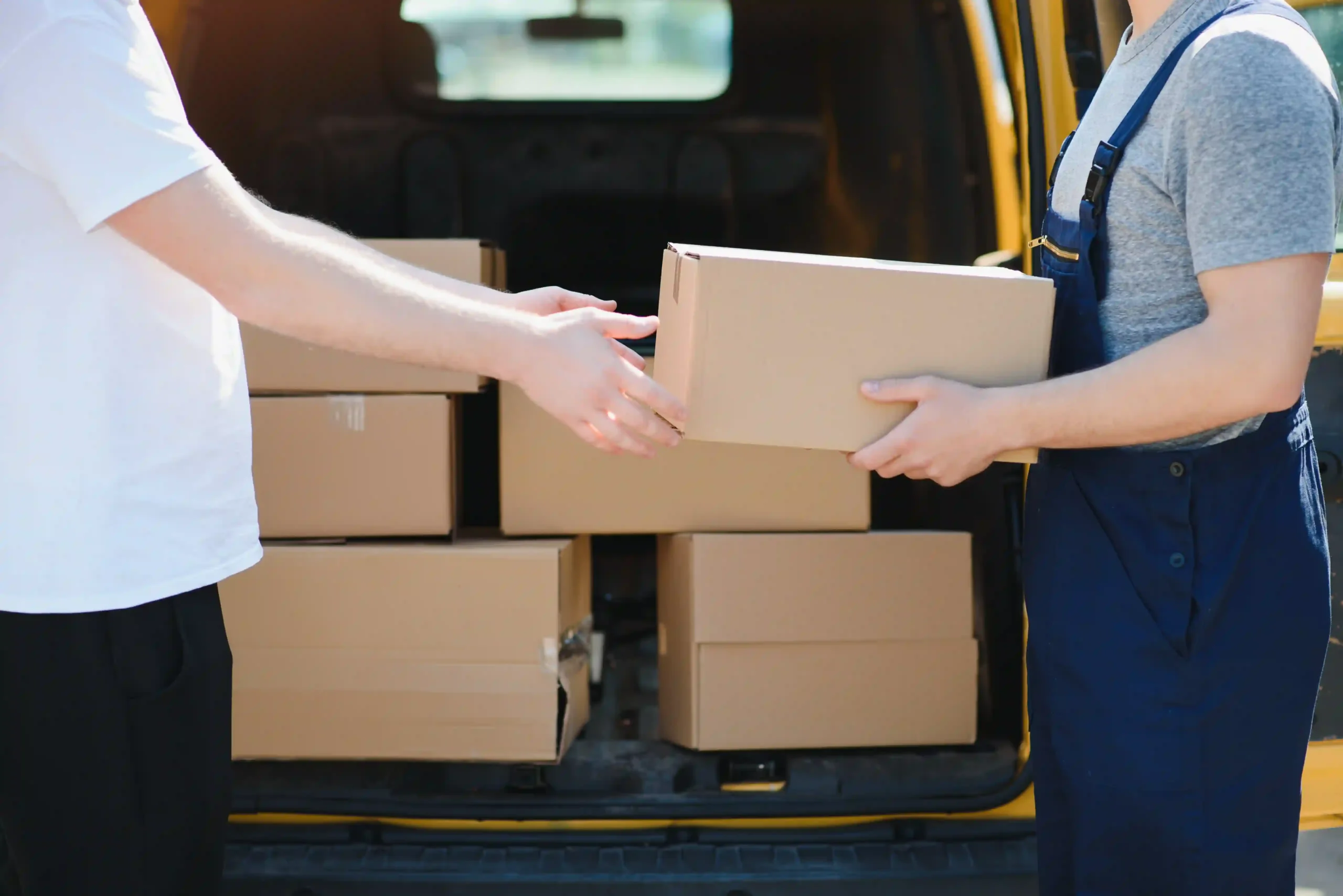 Delivery workers transferring packages from a van, demonstrating how cross docking is most closely related to last-mile efficiency and streamlined fulfillment.