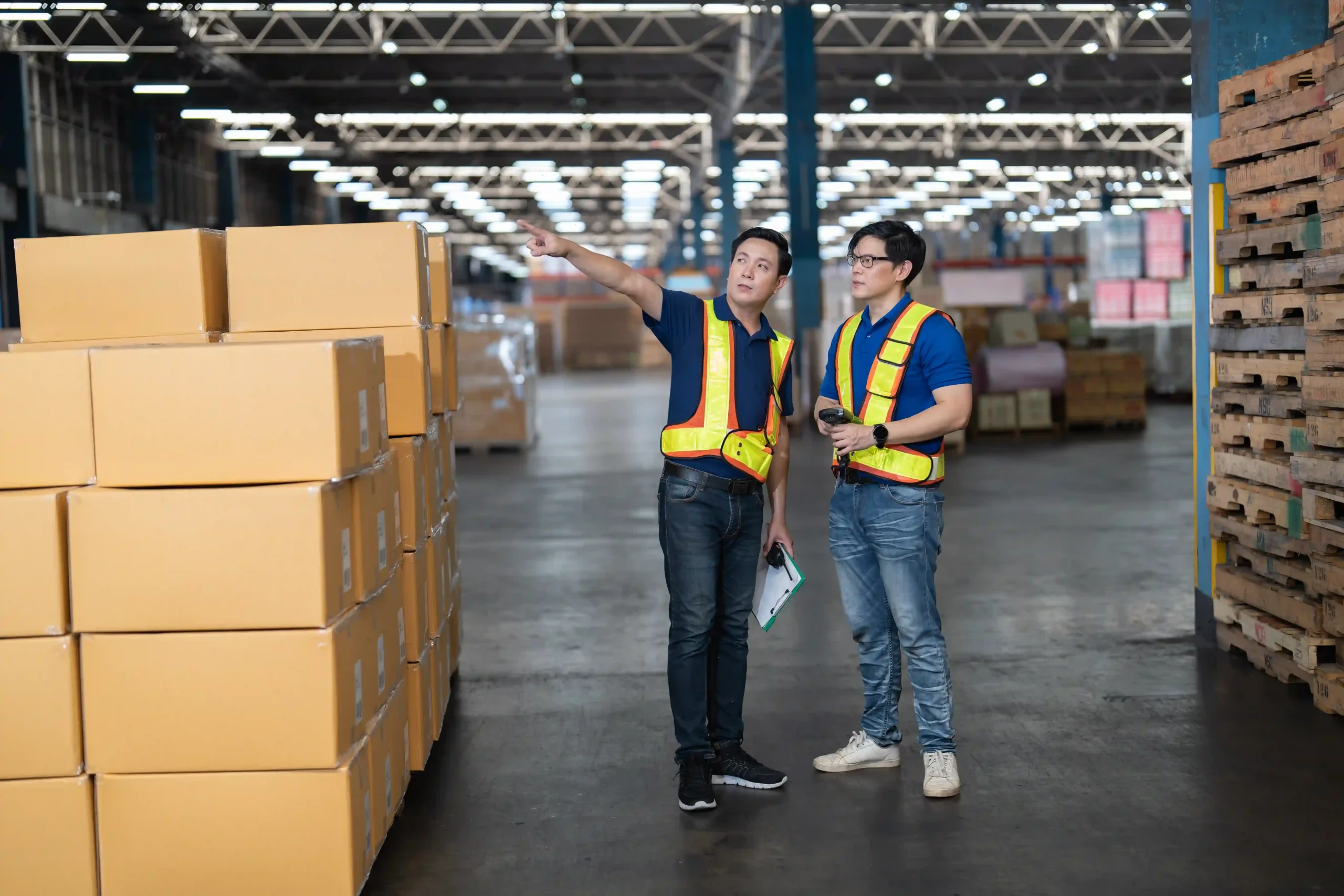 Logistics manager and staff inspect packages at one of our global industrial warehouse locations
