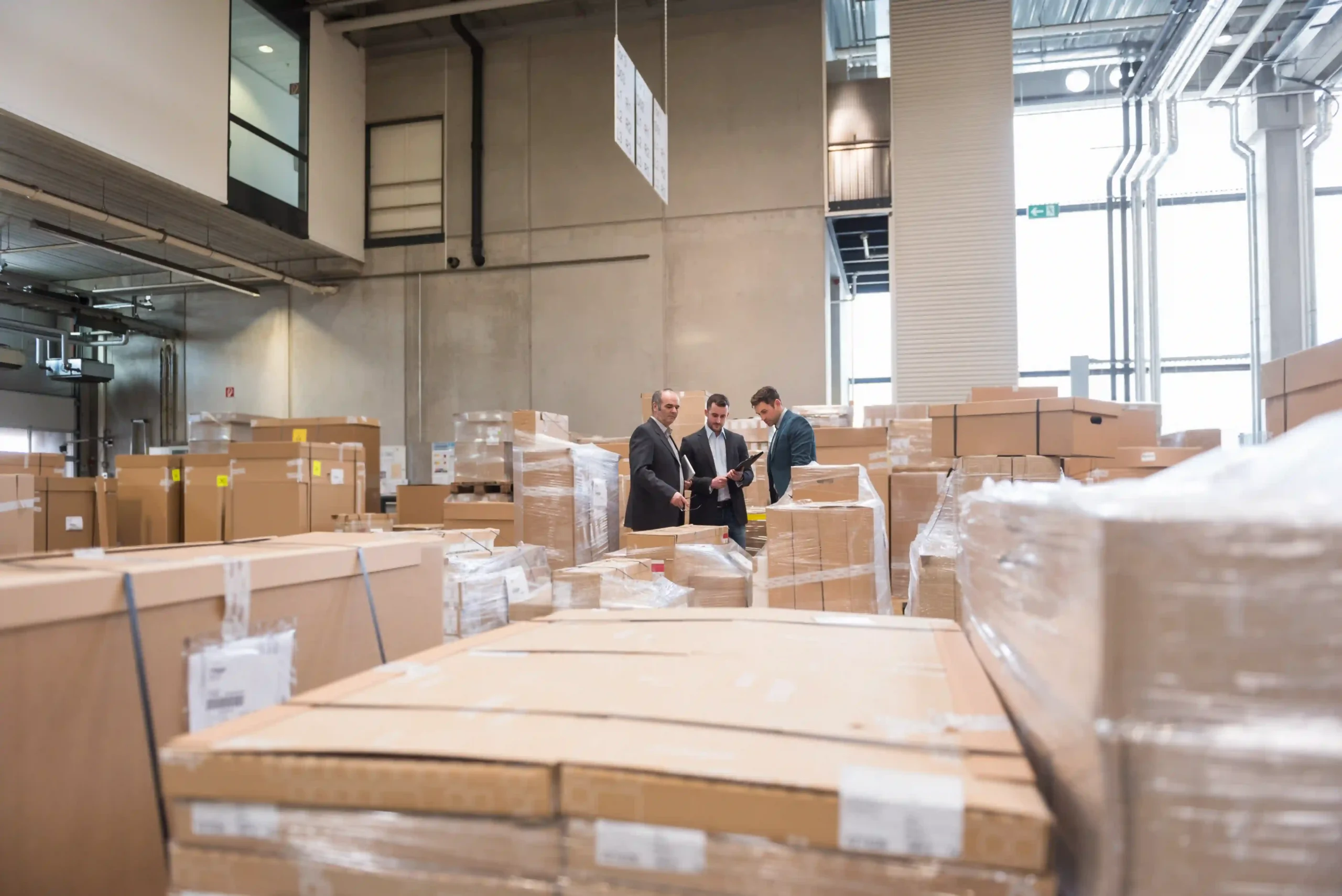 Businessmen reviewing logistics strategy in a warehouse as part of a nationwide 3PL network