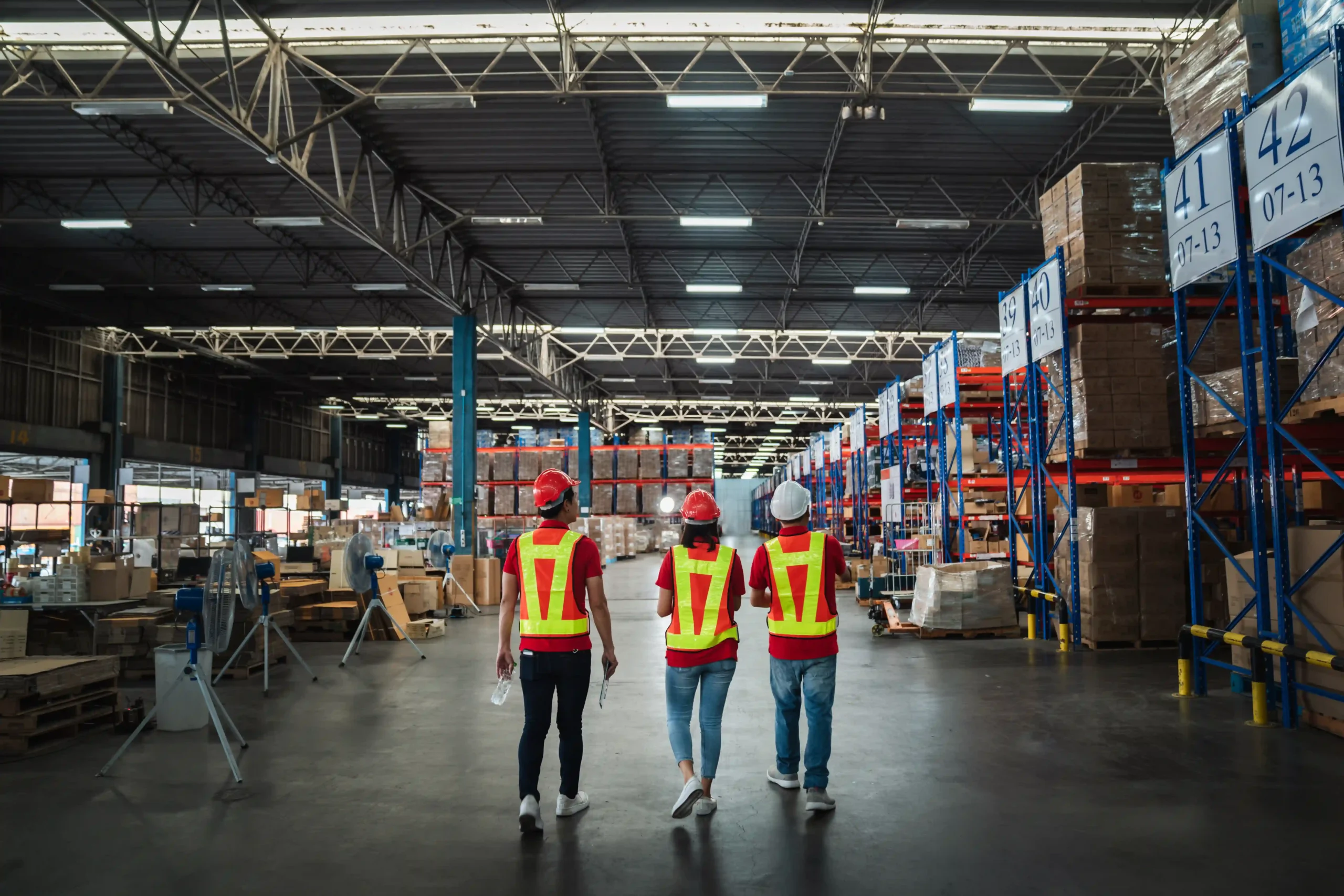 A group of FTZ in USA warehouse employees conducting a stock and operations check.