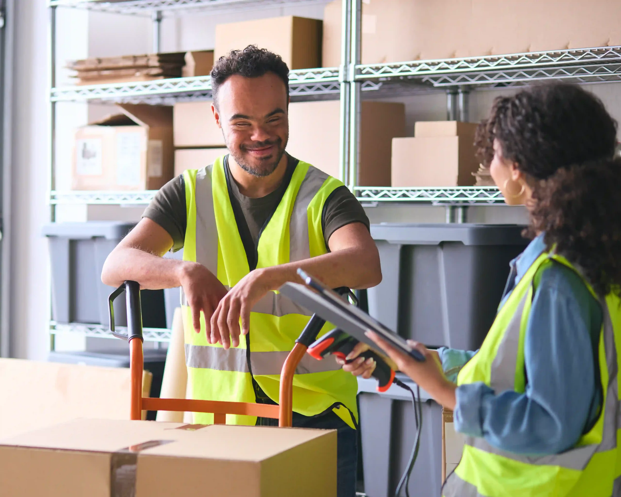 Team reviewing digital inventory as part of the 3PL logistics process in a warehouse setting