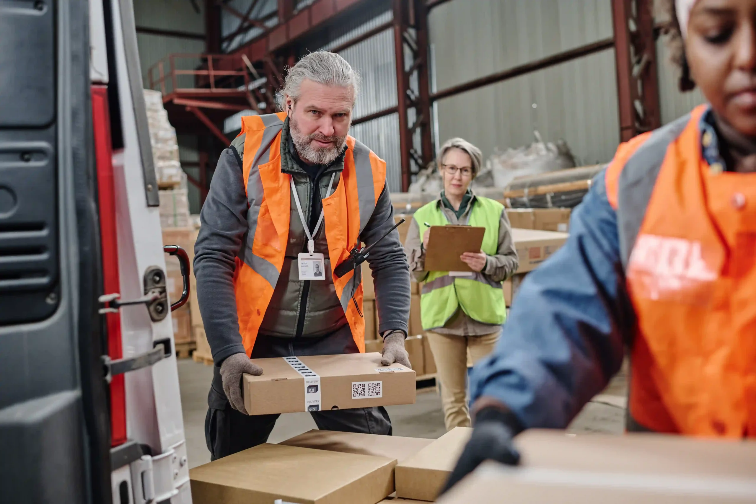 Team loads parcels for shipment from global industrial warehouse locations