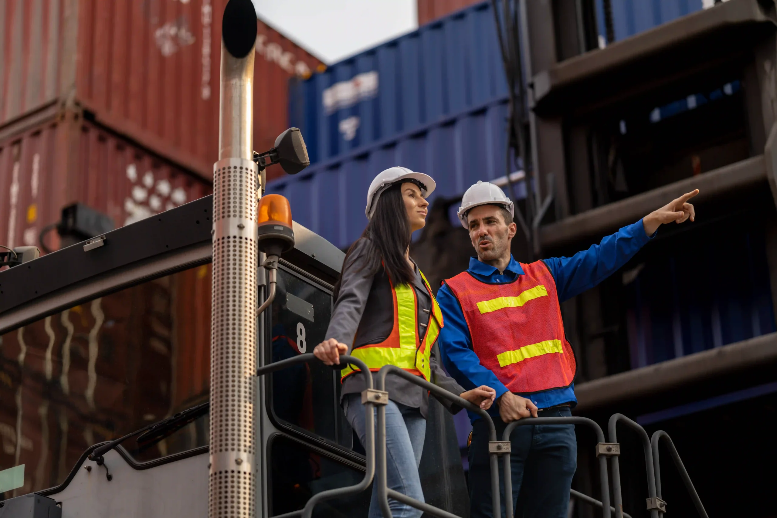 Warehouse professionals discussing export logistics after completing global trade compliance certification
