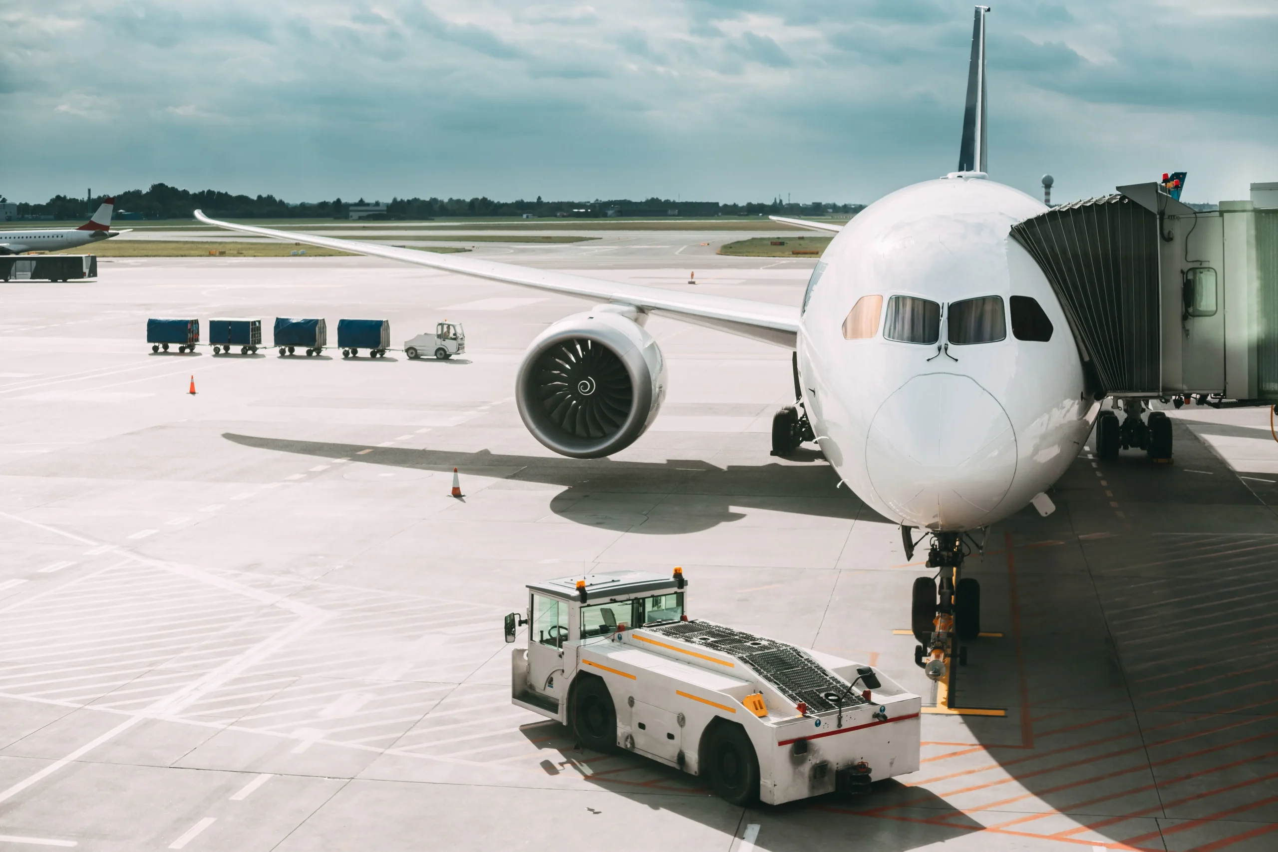 Aircraft connected to terminal with ground support equipment active in air transportation logistics workflow