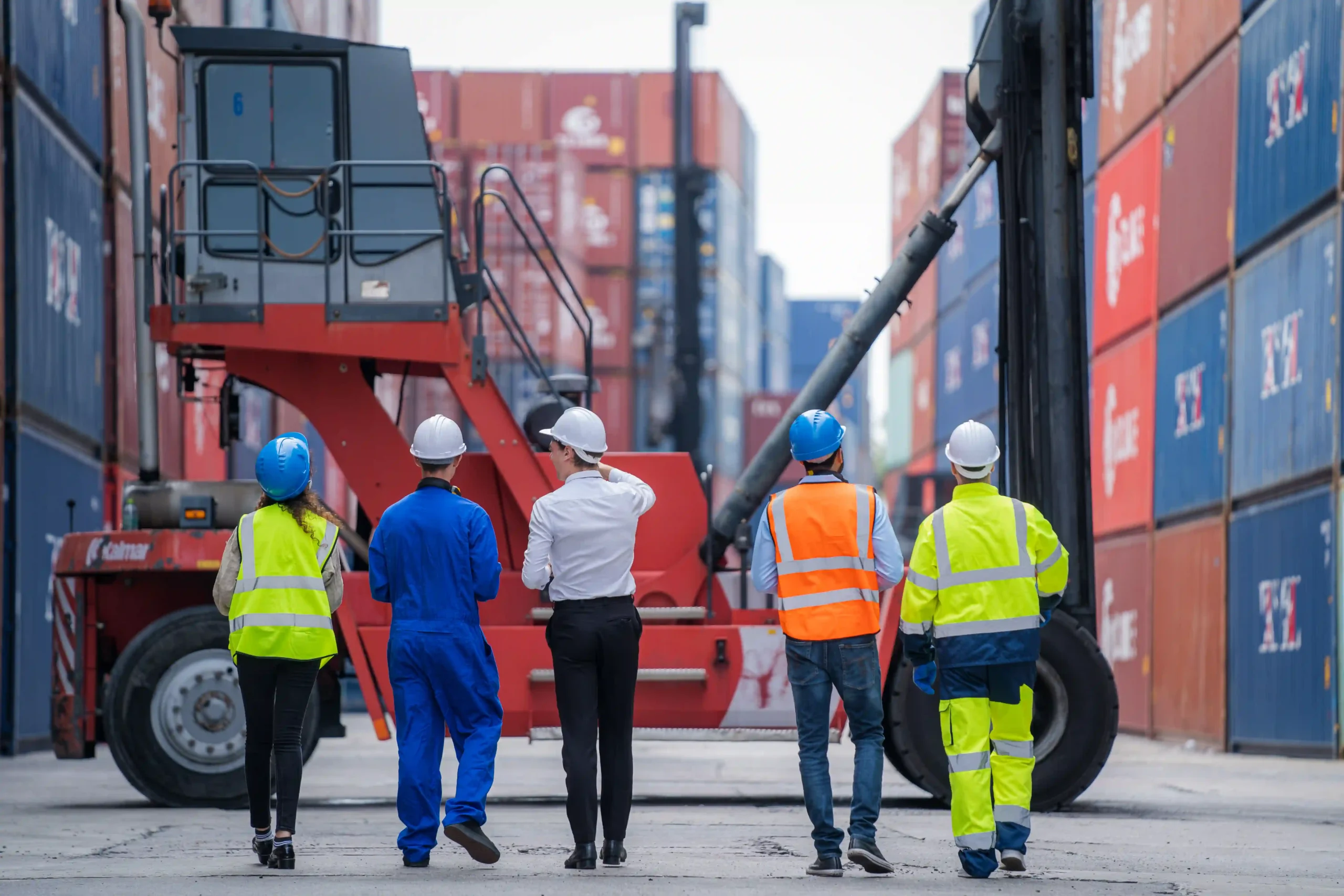Supply chain professionals inspecting shipping containers under foreign trade zone status