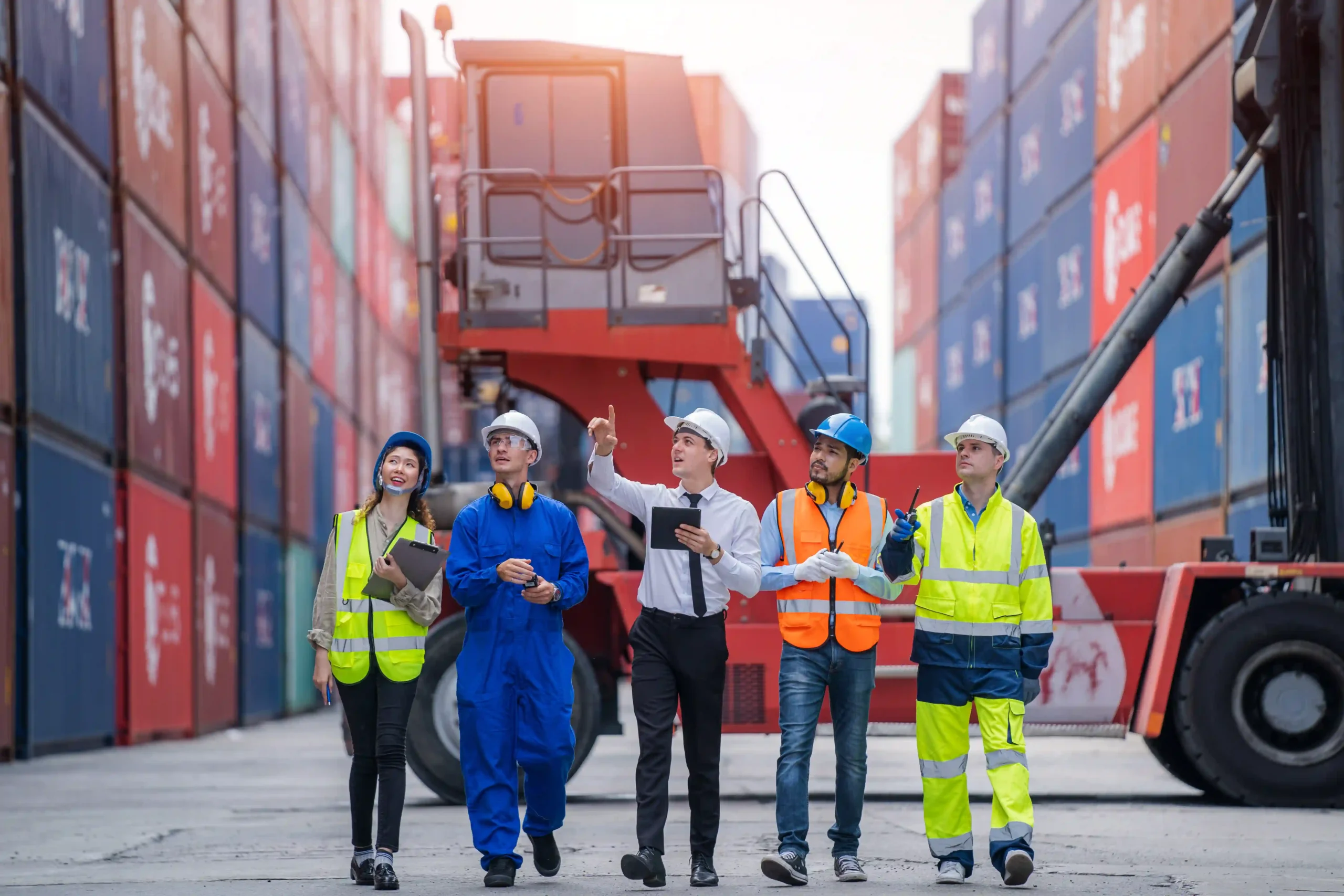 Businessman and logistics team coordinating freight operations as part of logistics and supply chain training program
