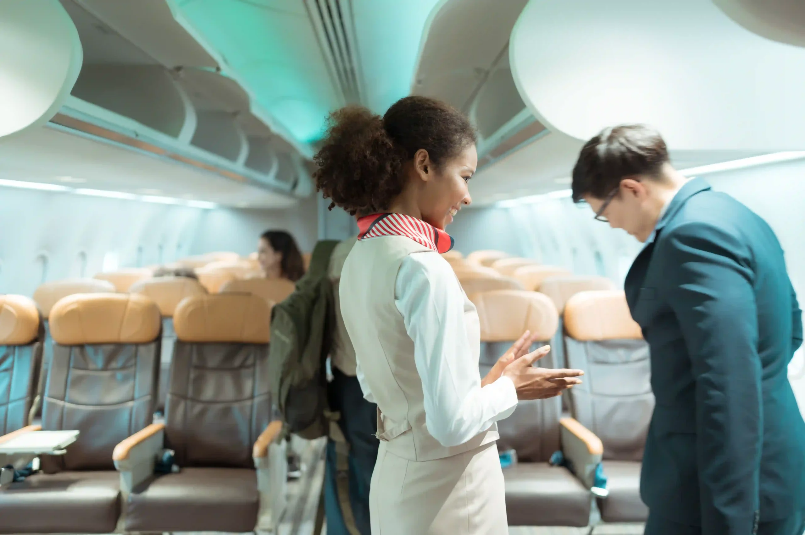Flight attendant assisting passengers in aircraft interior, supported by aviation logistics companies