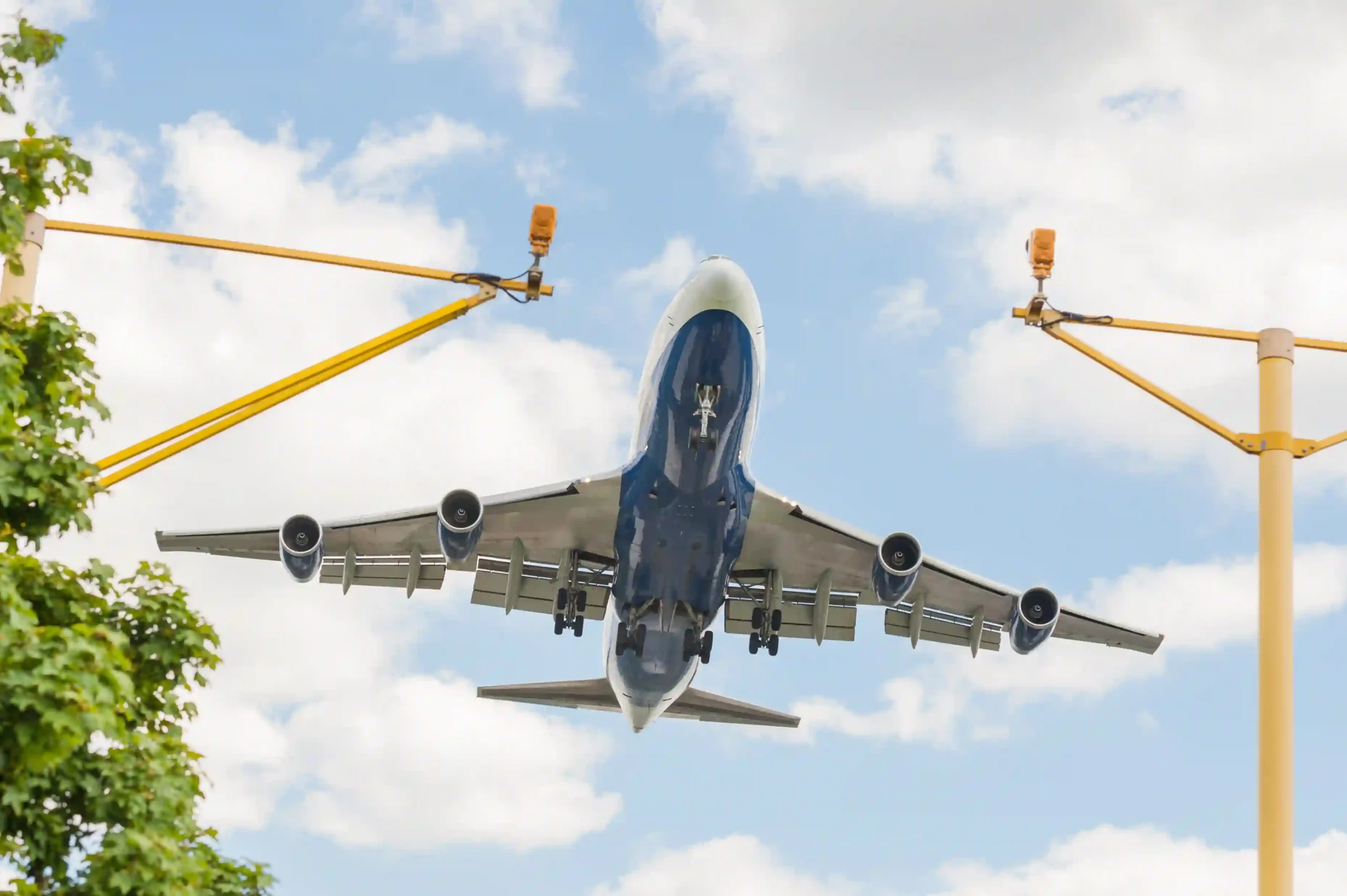 Commercial airplane landing under clear skies, illustrating global airline industry size in motion.