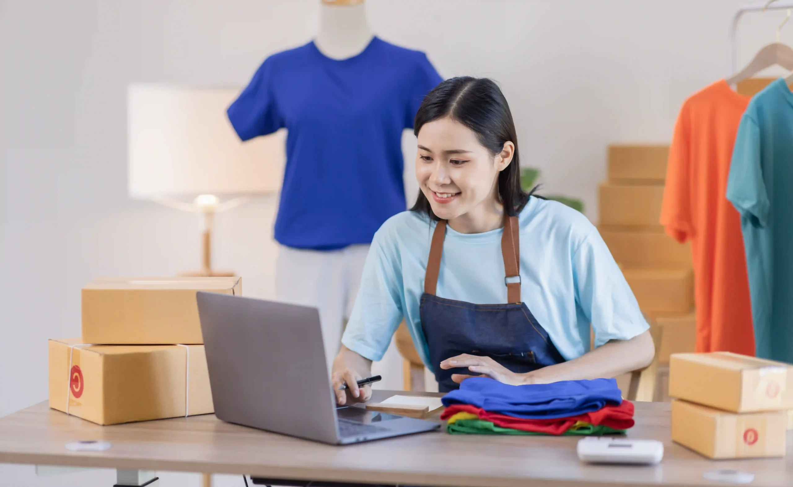 Ecommerce fulfillment for a clothing business with a female entrepreneur organizing online orders.