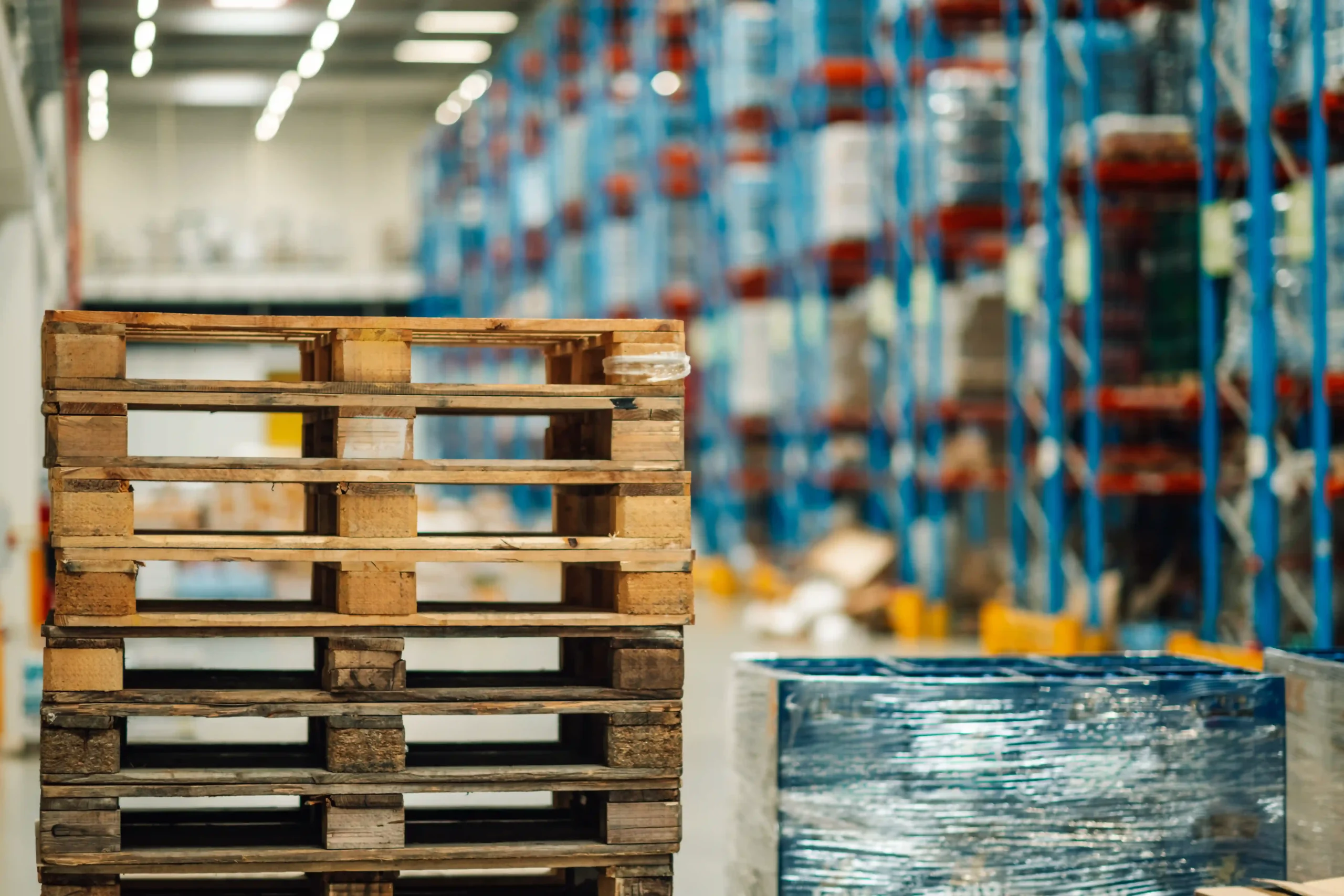 Close-up of wooden pallets and stretch film, ready for use with a warehouse pallet wrapper.