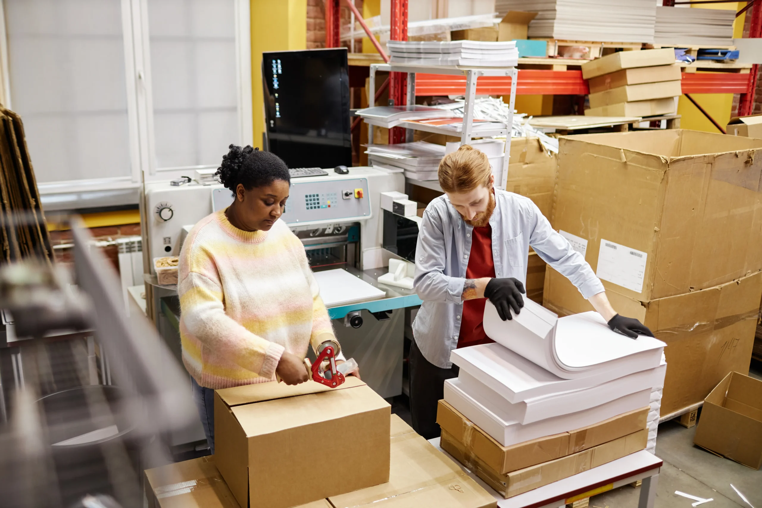 Fulfillment team organizing shipments and packaging with support from an order fulfillment dashboard